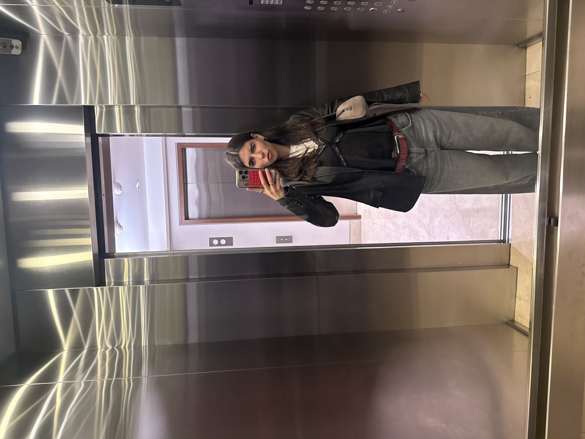 Woman takes morning selfie in Mexico City elevator