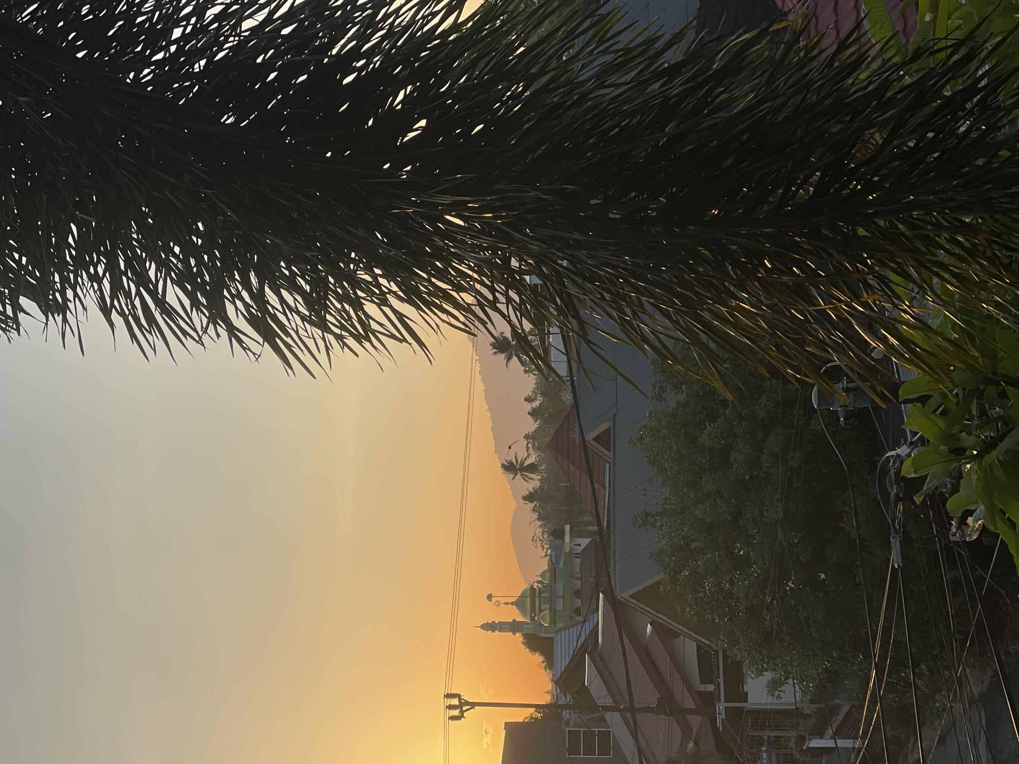 Golden hour over Manado, mosque and rooftops in view