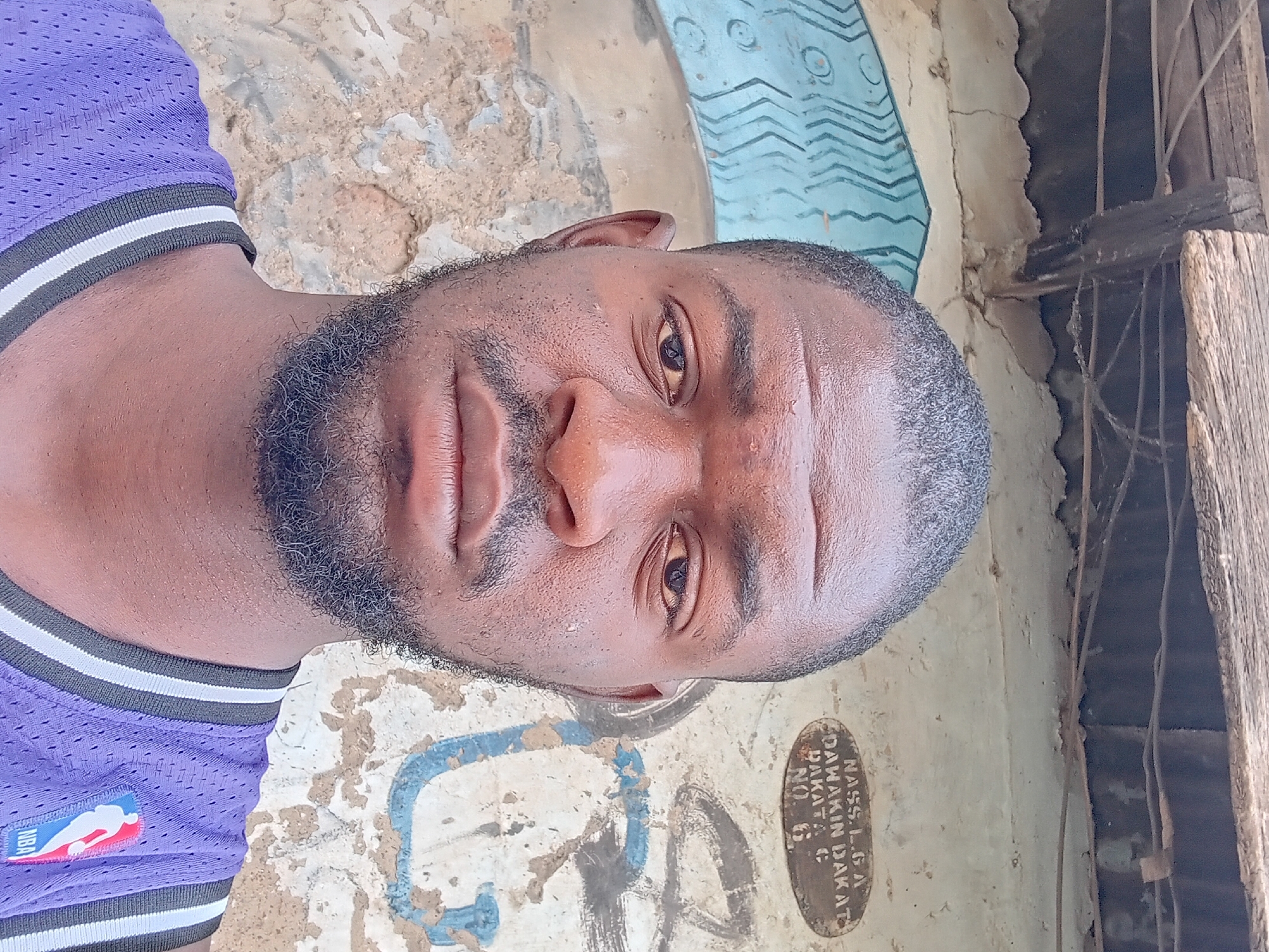Person spotted on unpaved ground in Dakata, Nigeria