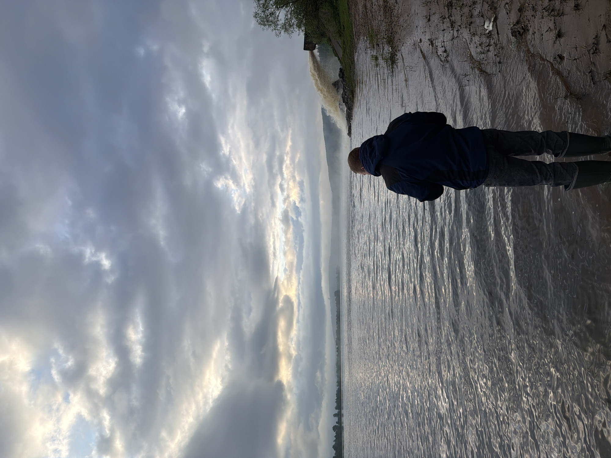 Person observed at water's edge in rural Russia