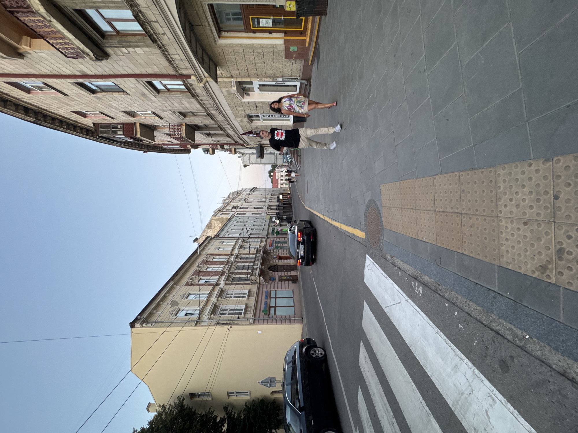Evening streets of Chernivtsi, red lily and city blocks