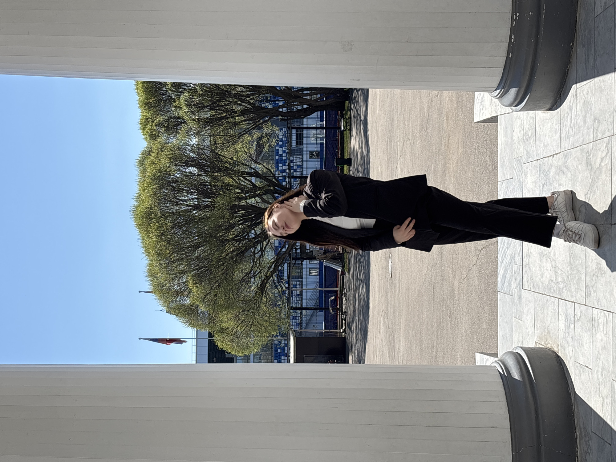 Woman in business suit photographed at marble columns in Perm