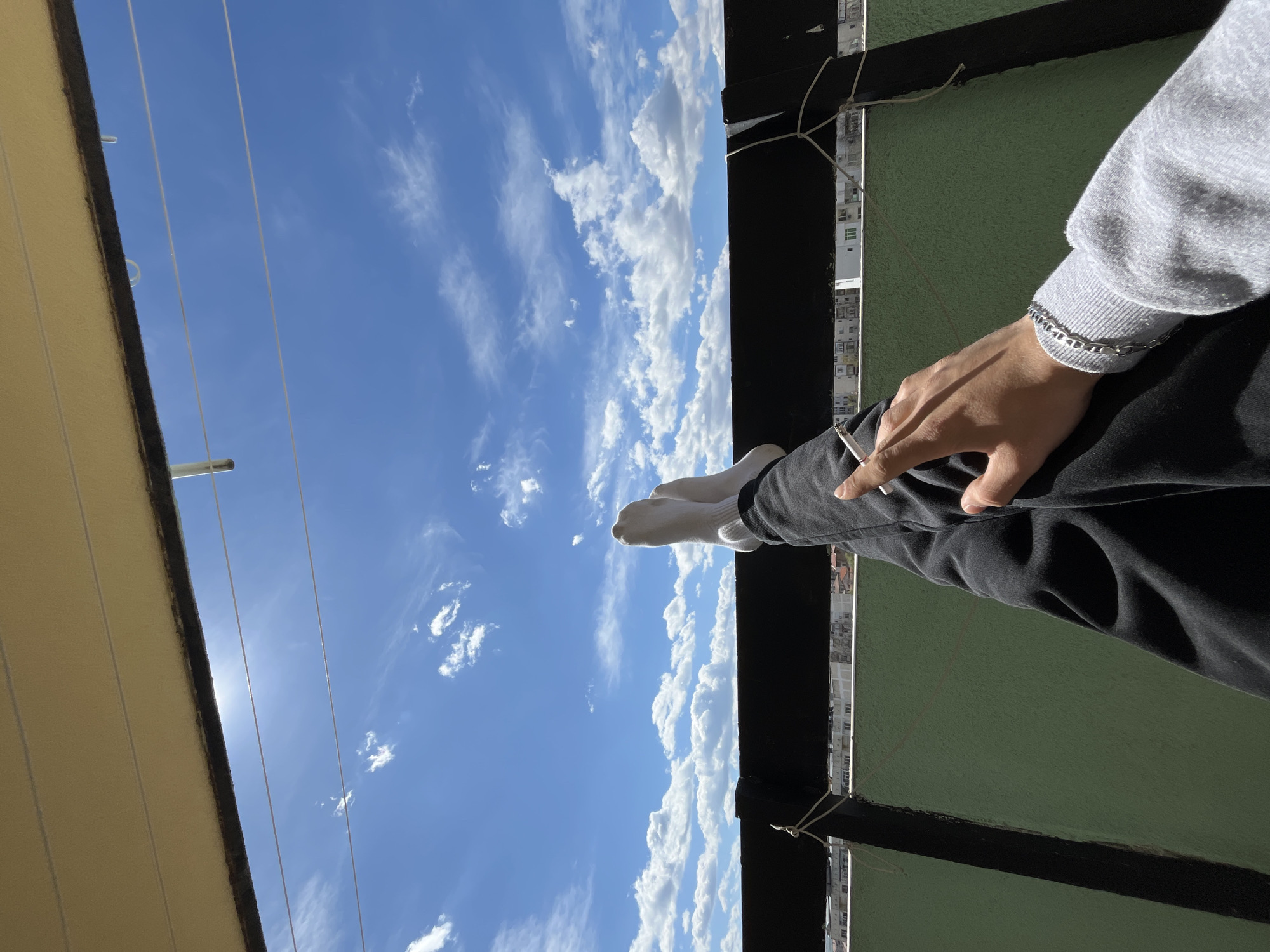 Young man spends morning on Bulgarian balcony smoking, taking selfies