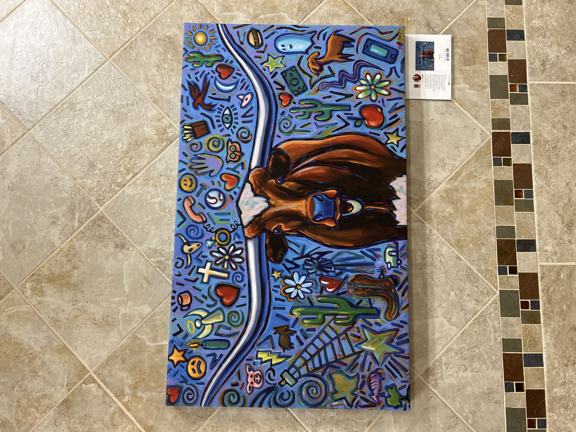 Texas Longhorn painting with bold colors and symbol-filled background