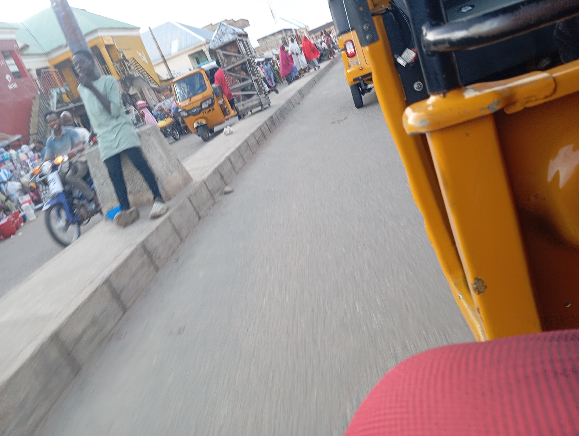 Riding through Jalingo's streets in a yellow tuk-tuk
