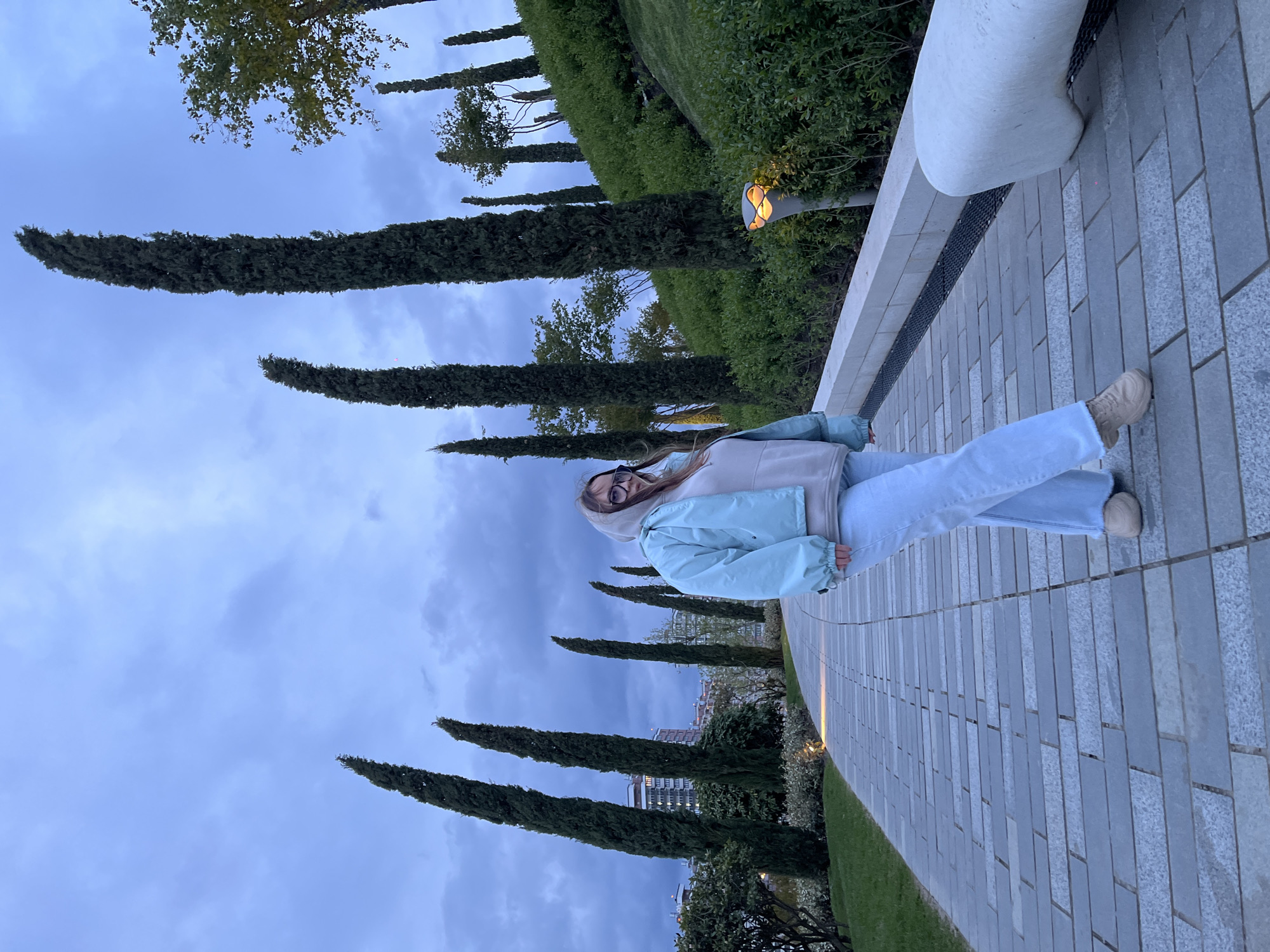 Woman photographed at modern Krasnodar park complex at twilight