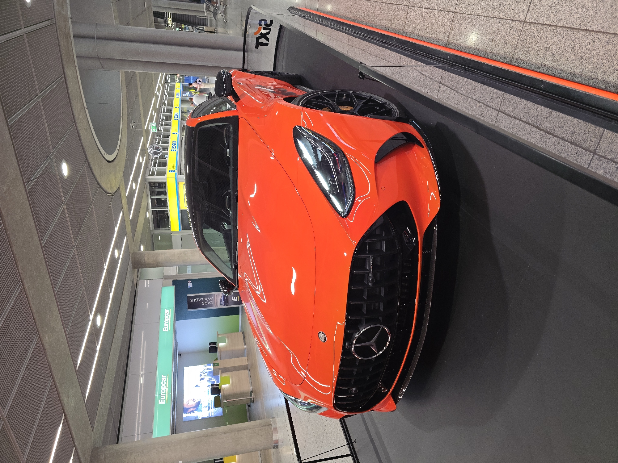 Orange Mercedes-AMG GT on display at Stuttgart Airport