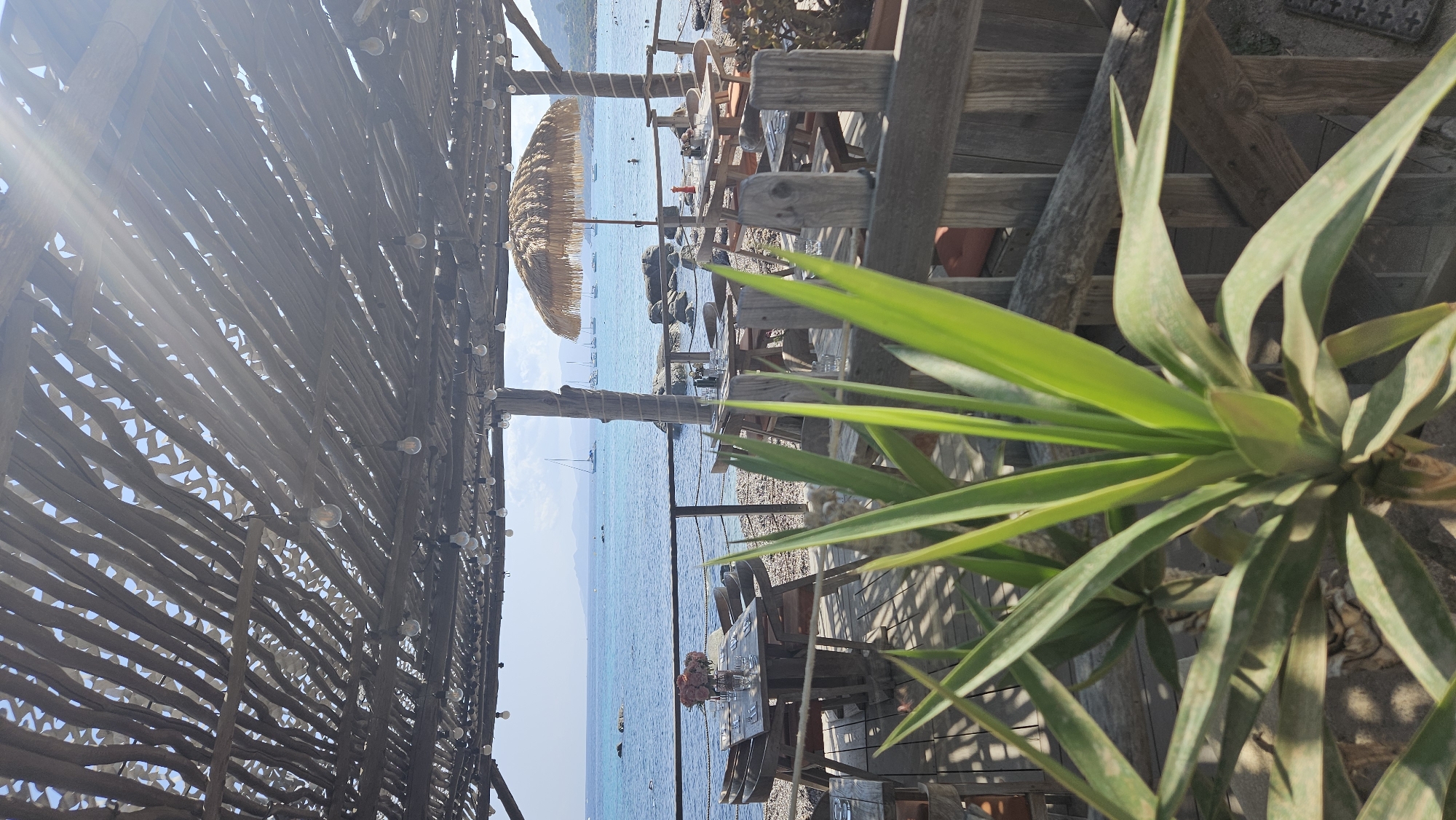 L'Île-Rousse beach morning: sand, sea, and seaside patios
