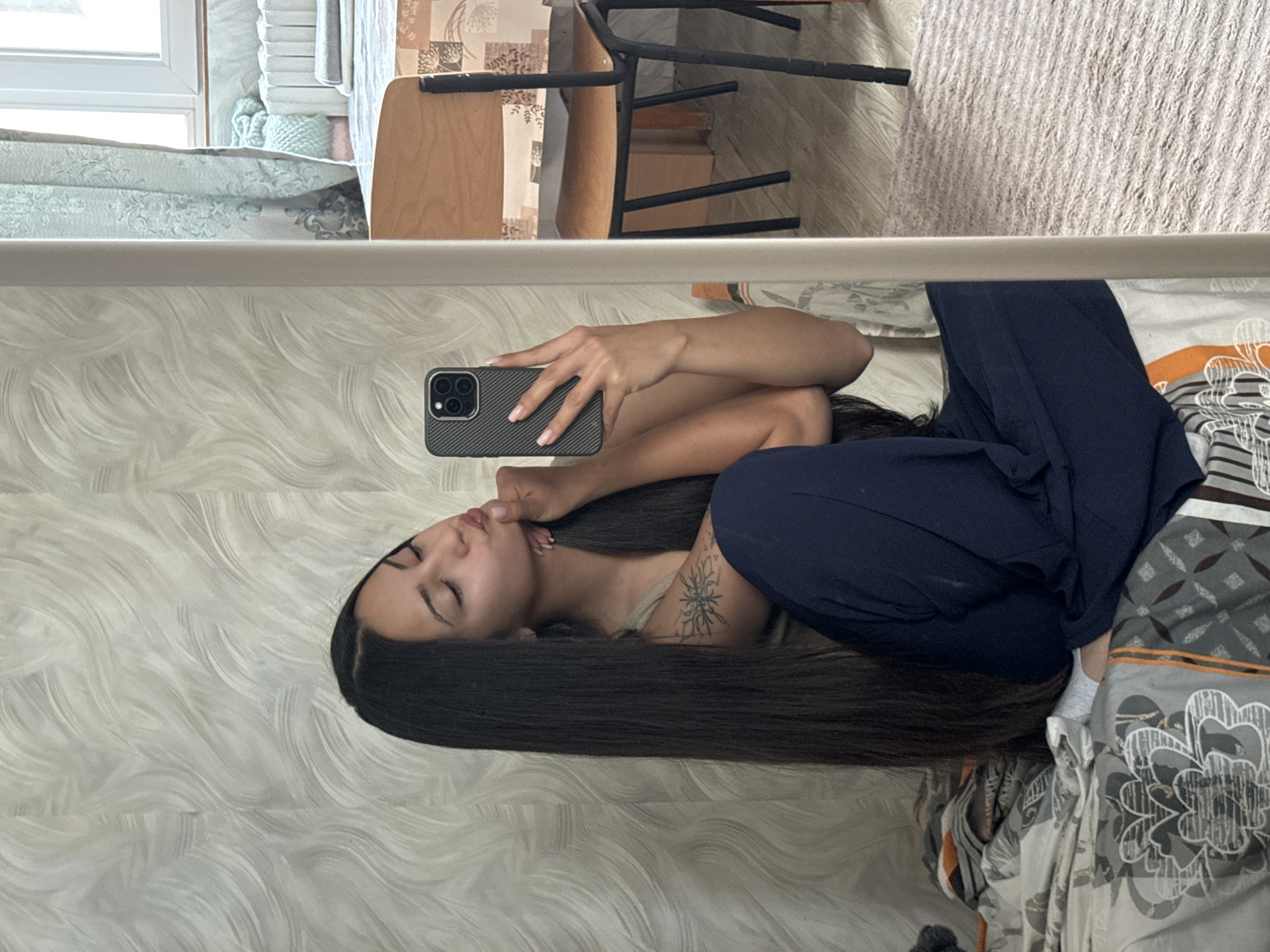 Woman takes early morning selfies in Sofia bedroom