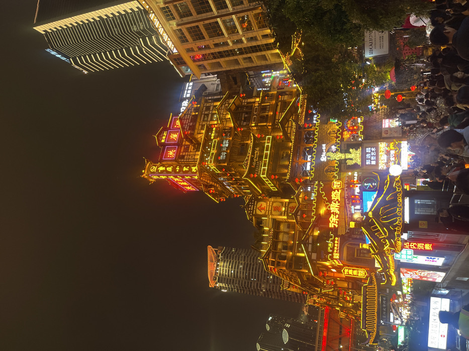 Nighttime crowds, traditional dress photography at Chongqing's Hongyadong complex
