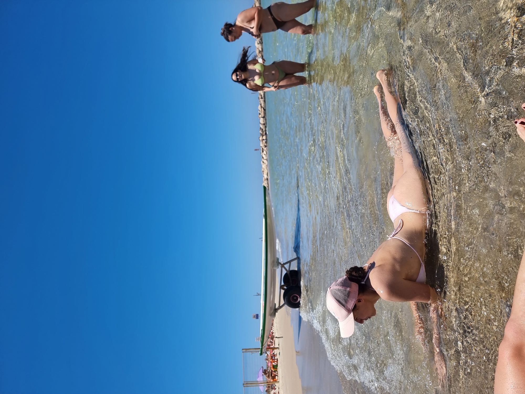 Two women enjoy sunny Friday morning at Tel Aviv beach