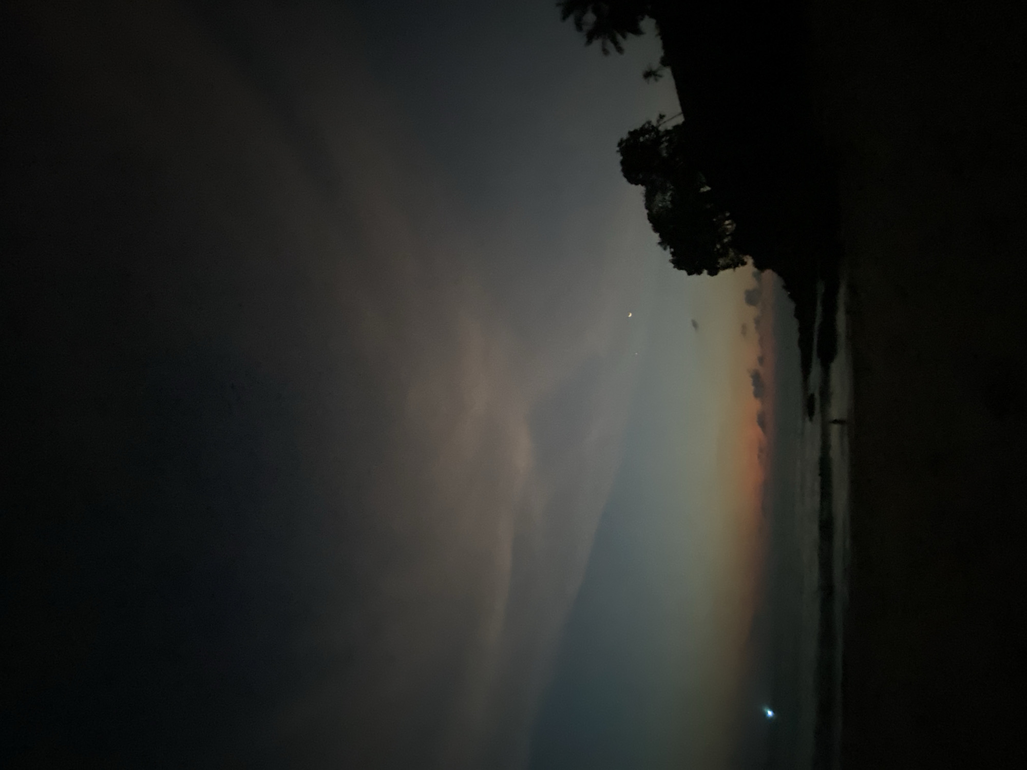 Twilight beach scene with crescent moon observed in Thailand