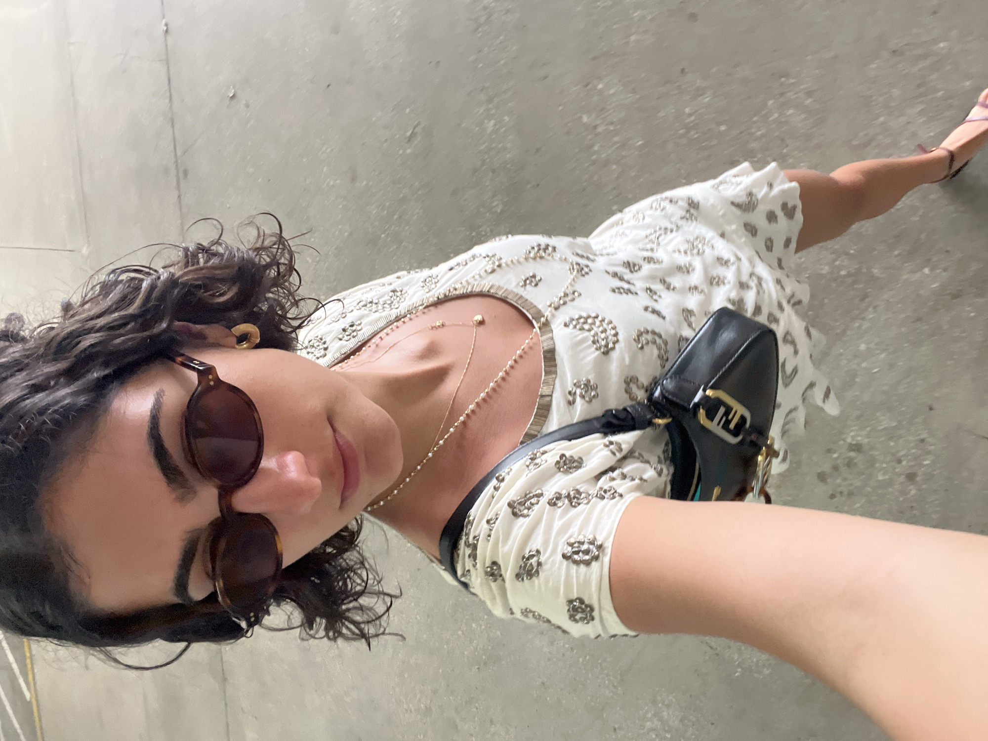 Woman in white dress spotted on Miami concrete surface