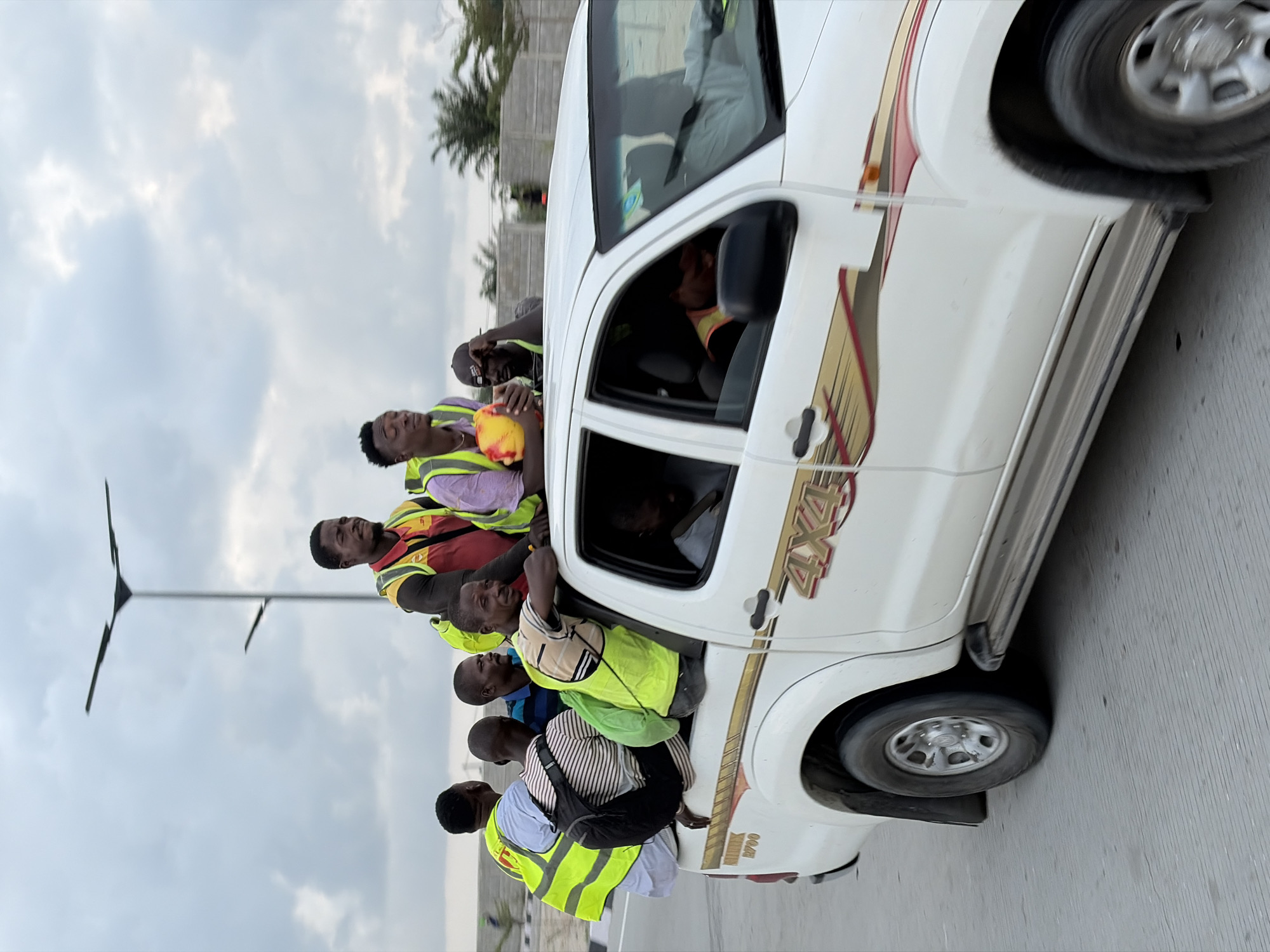 Workers transported by truck under stormy skies in Alaguntan