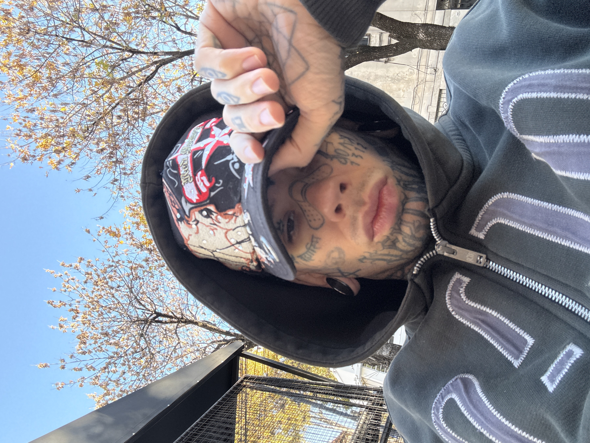 Heavily tattooed person documented in Buenos Aires with social posts