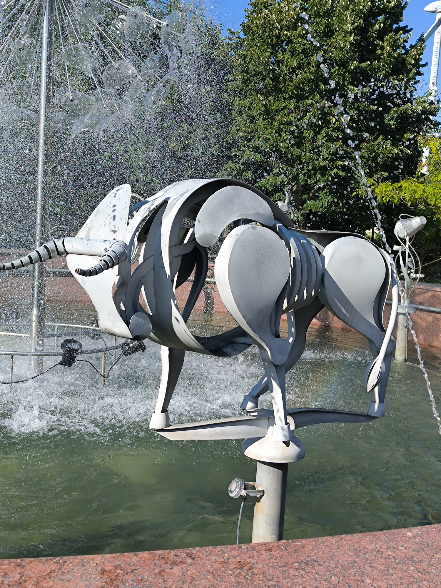 Chișinău park's fountain and sculpture collection on a summer afternoon