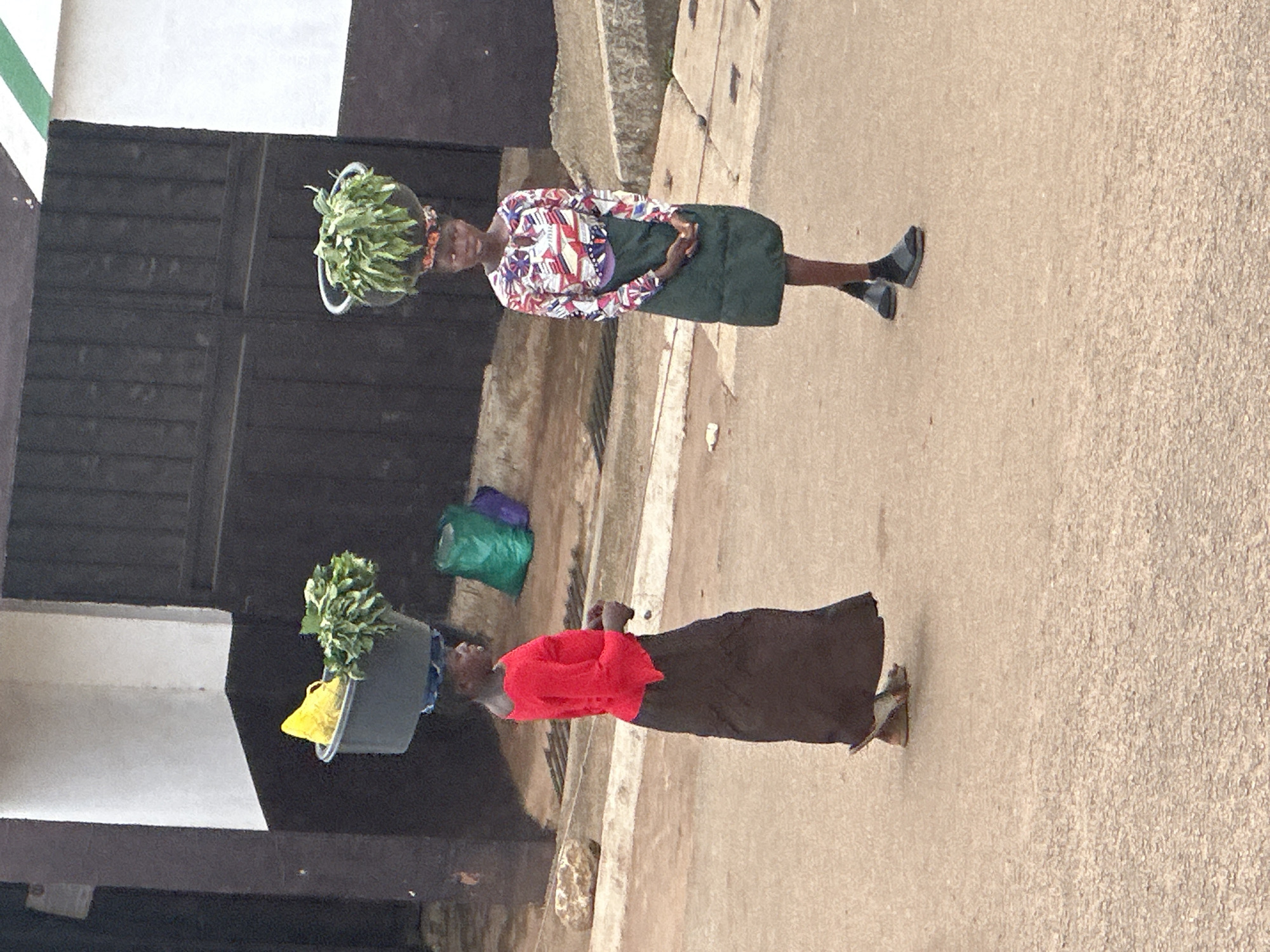 Afternoon street life along Bukuru's busy commercial corridor