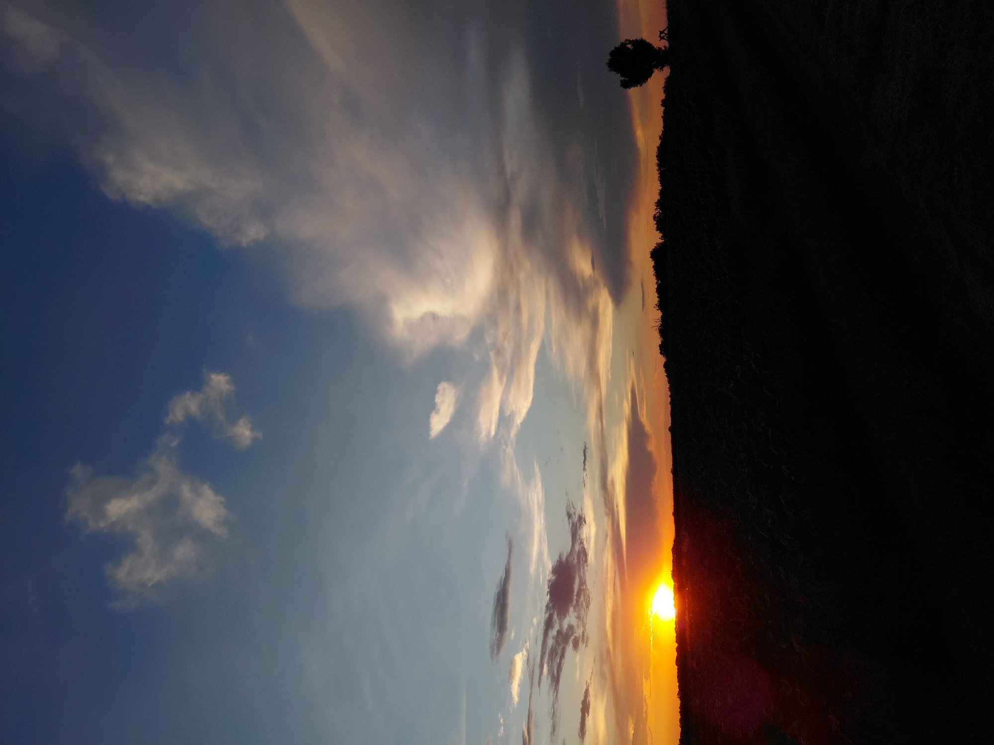 Rural sunset scenes with Ukrainian flags documented across farmland