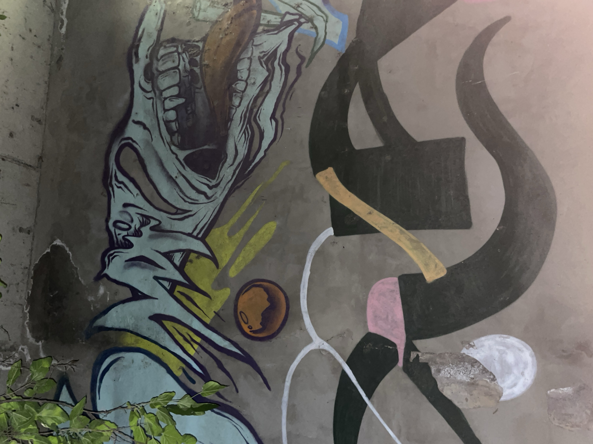 Grotesque character graffiti on a Tbilisi concrete wall