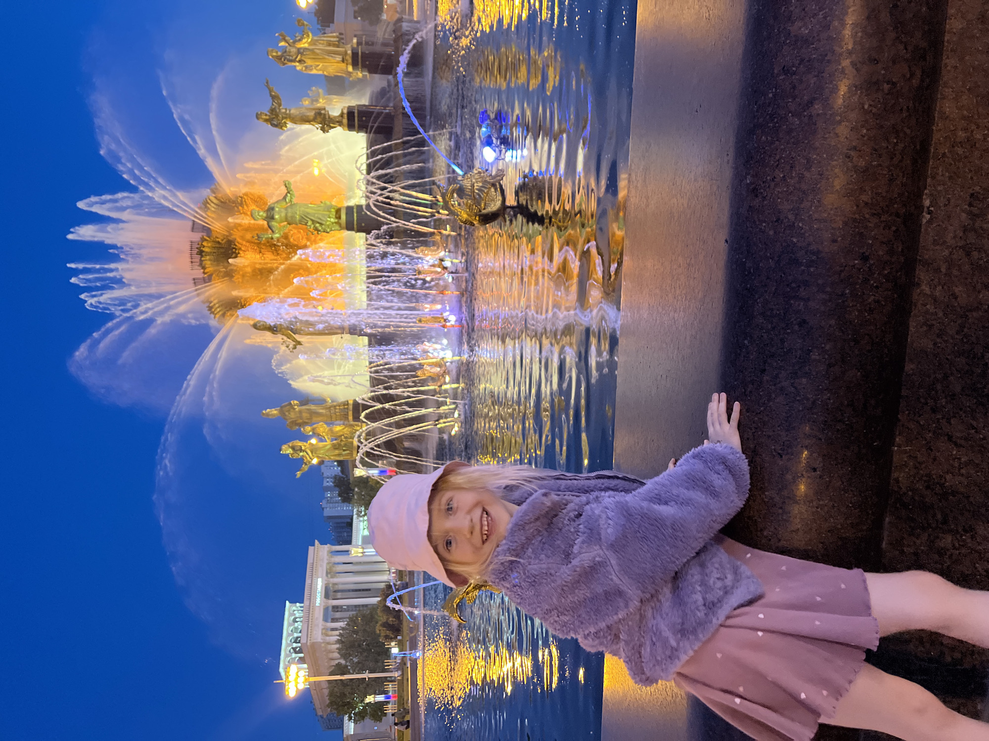 Evening visitors enjoy illuminated fountain at Moscow's VDNKh complex
