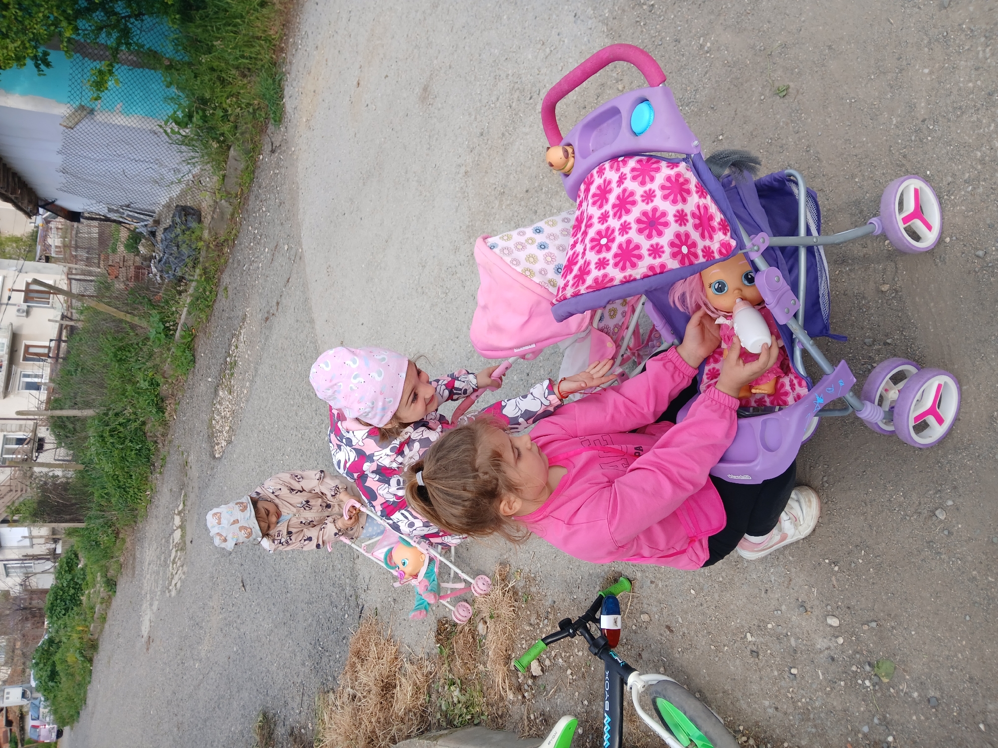 Children play with toys on residential streets in Obrochishte