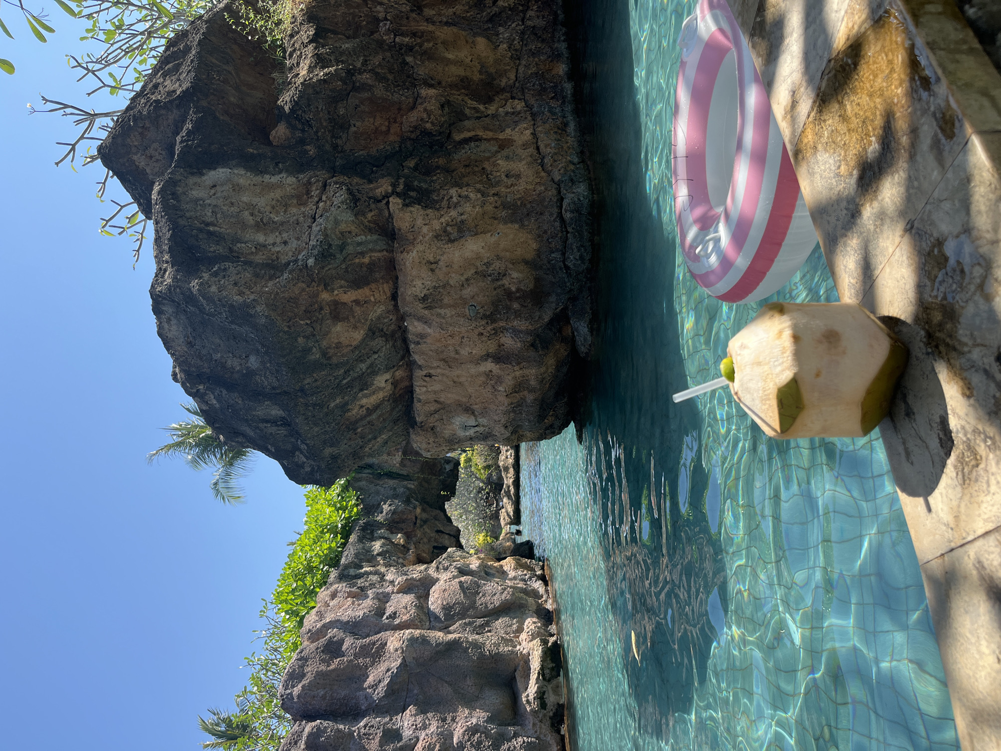 Lazy afternoon at a Bali resort pool with rock formations