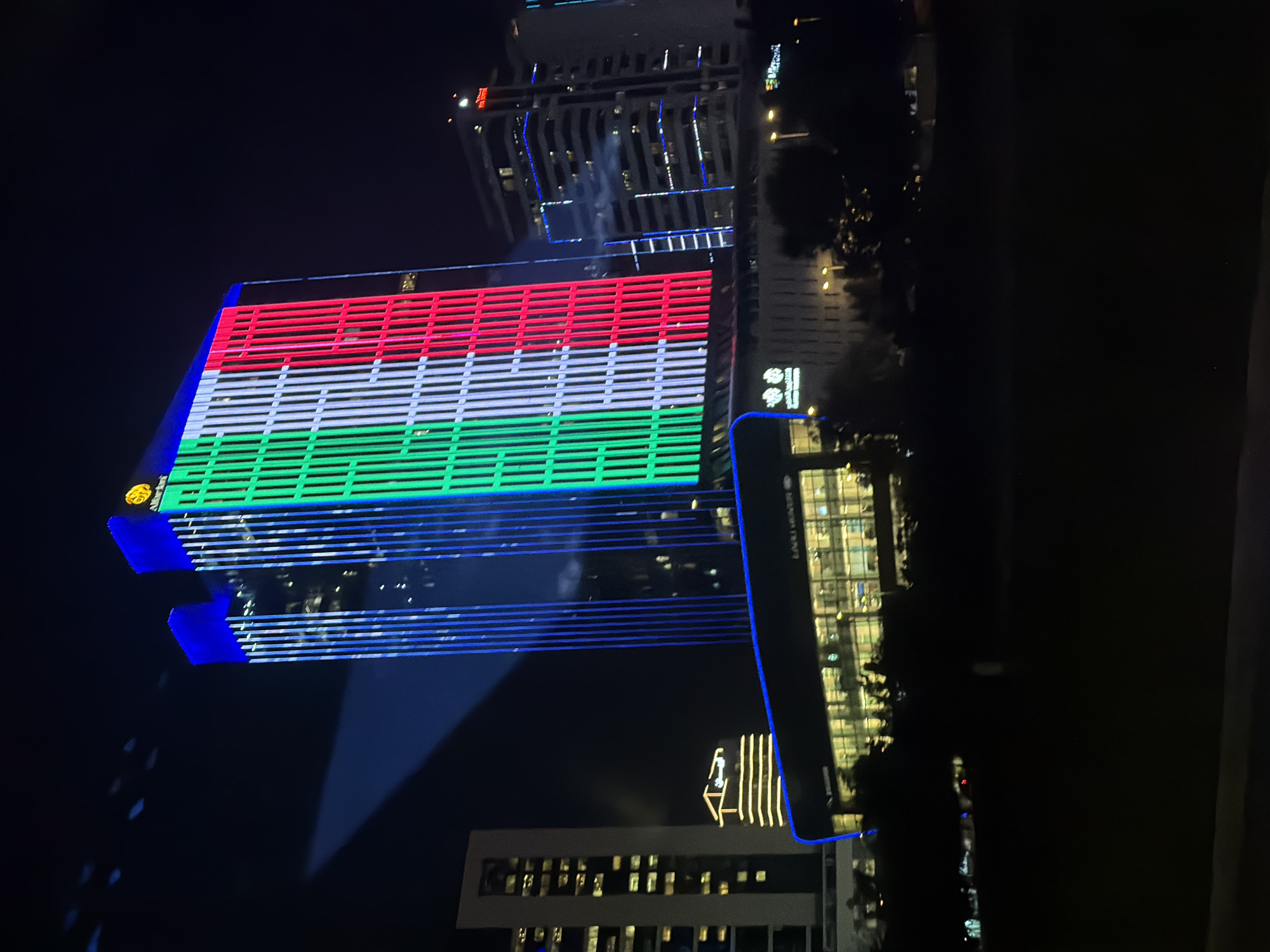 Lusail skyscraper displays illuminated Qatar flag at night