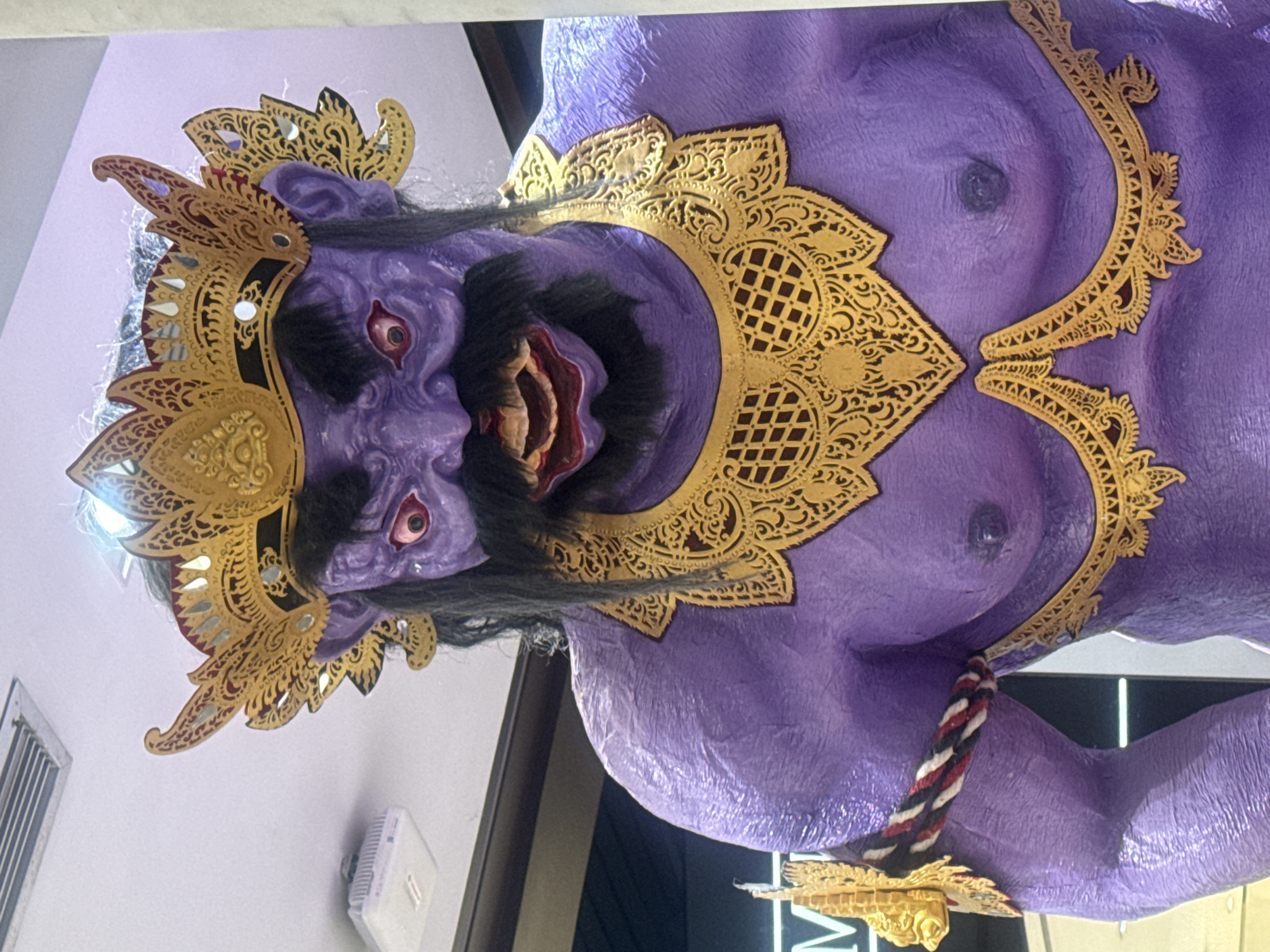 Traditional Balinese masks and statues displayed in Kuta commercial space