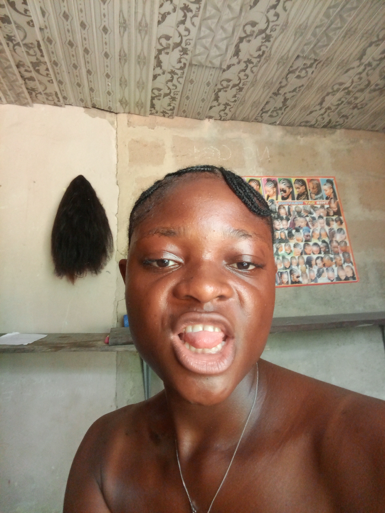 Woman documents hair styling session in Uyo salon