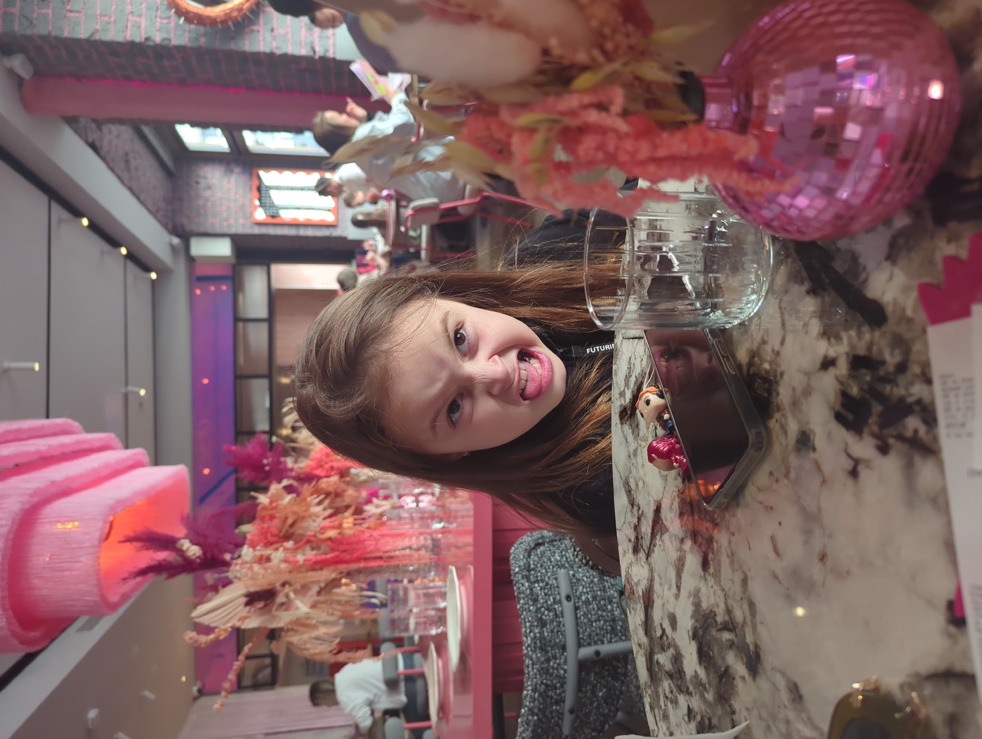 Child plays at camera during Moscow restaurant visit