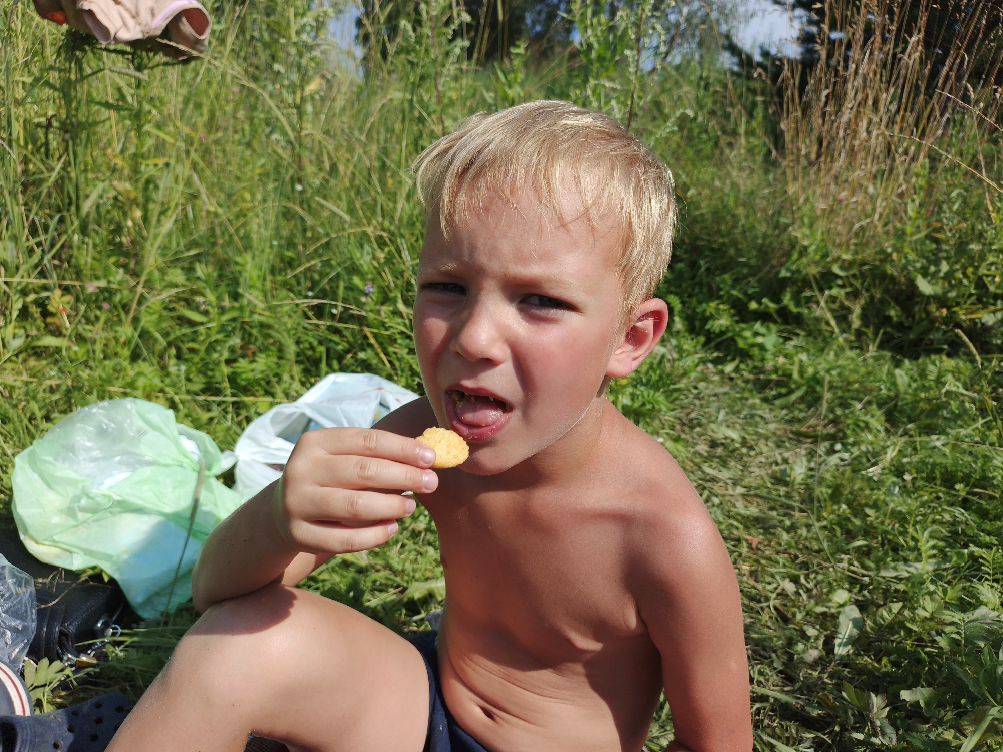 Kids and a fisherman spend a summer morning by the Urtiushka river