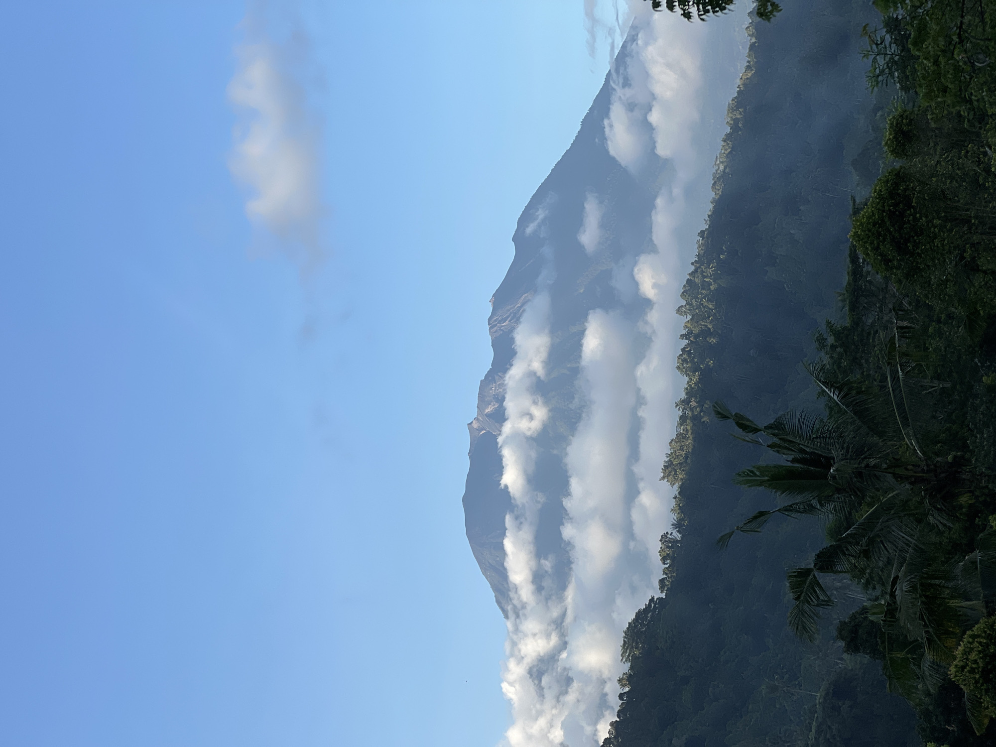 Mount Agung viewed through clouds from Sidemen, Indonesia