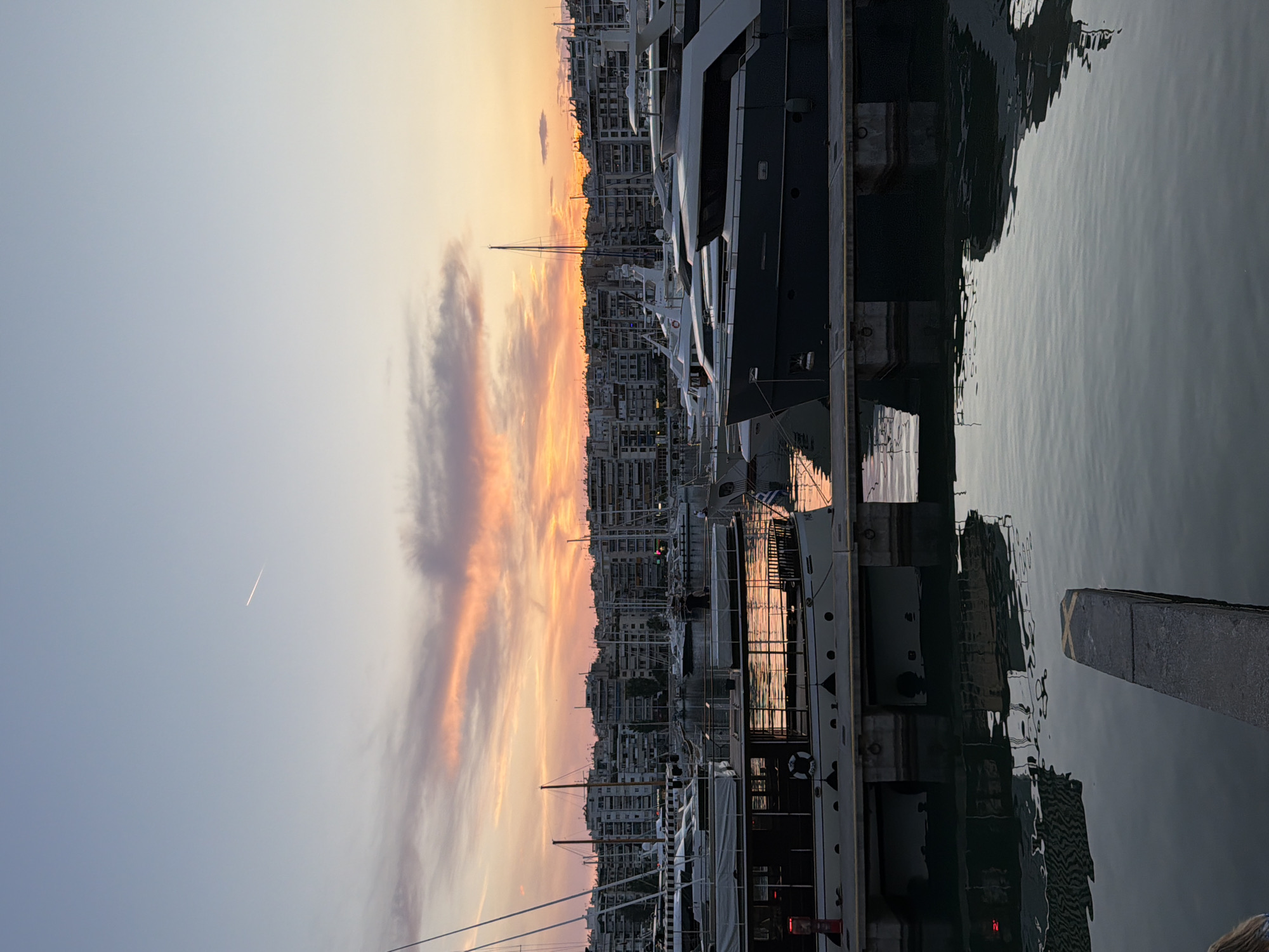 Evening sunset captured at Piraeus harbor with dining and street life