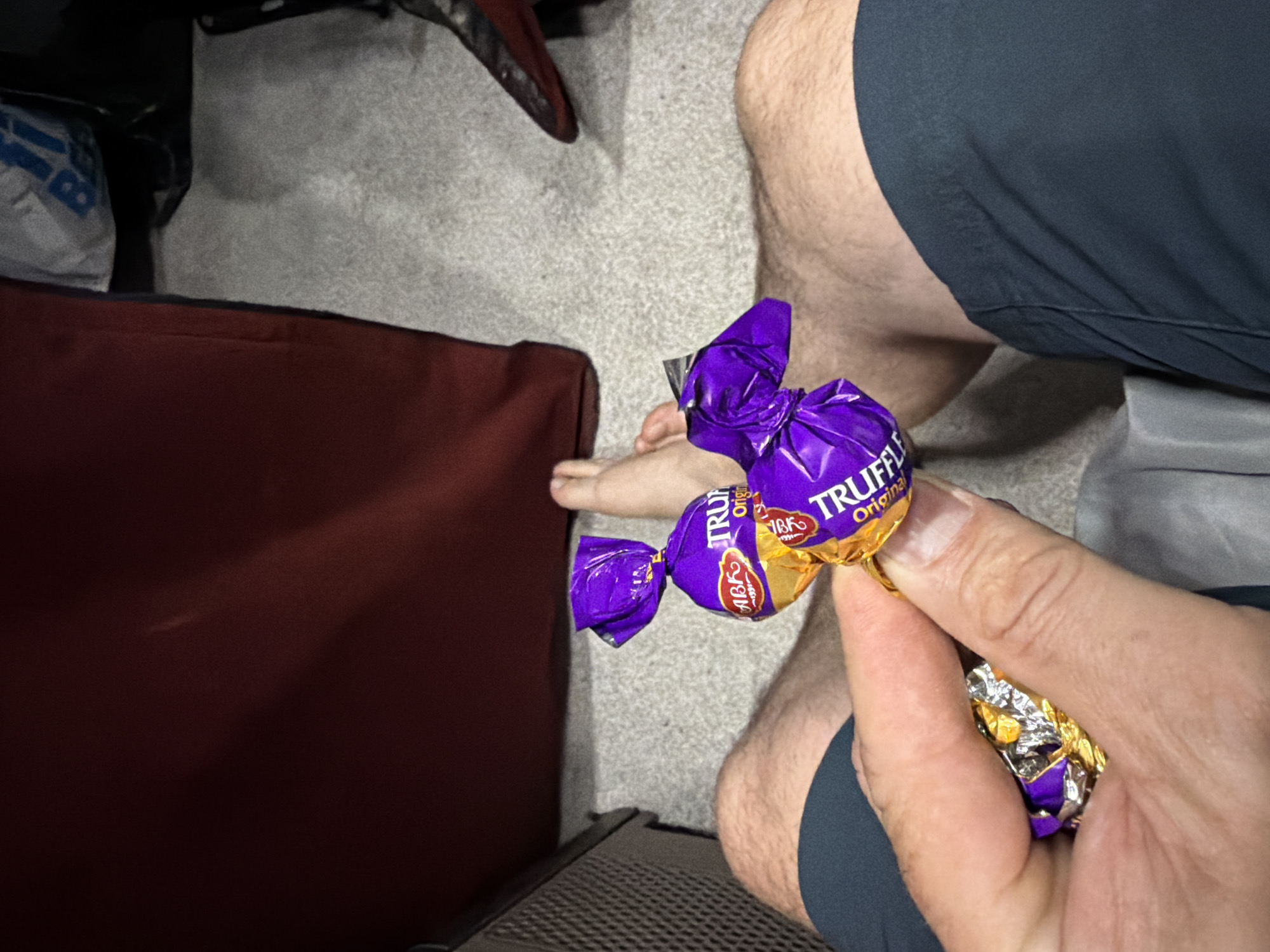 Person enjoys Truffle Original candies in early morning Elgin