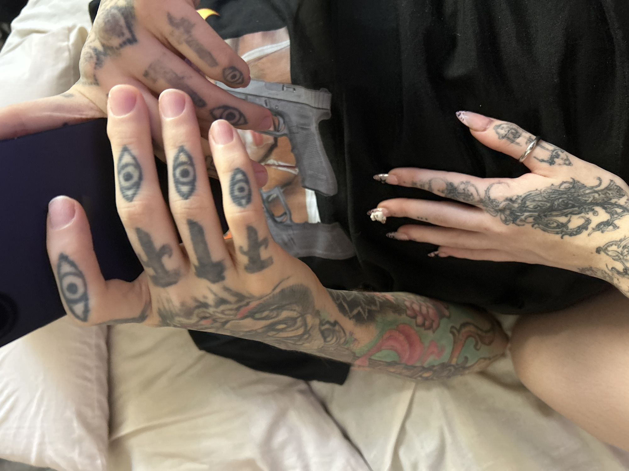 Intimate moment captured between tattooed individuals in Buenos Aires bedroom