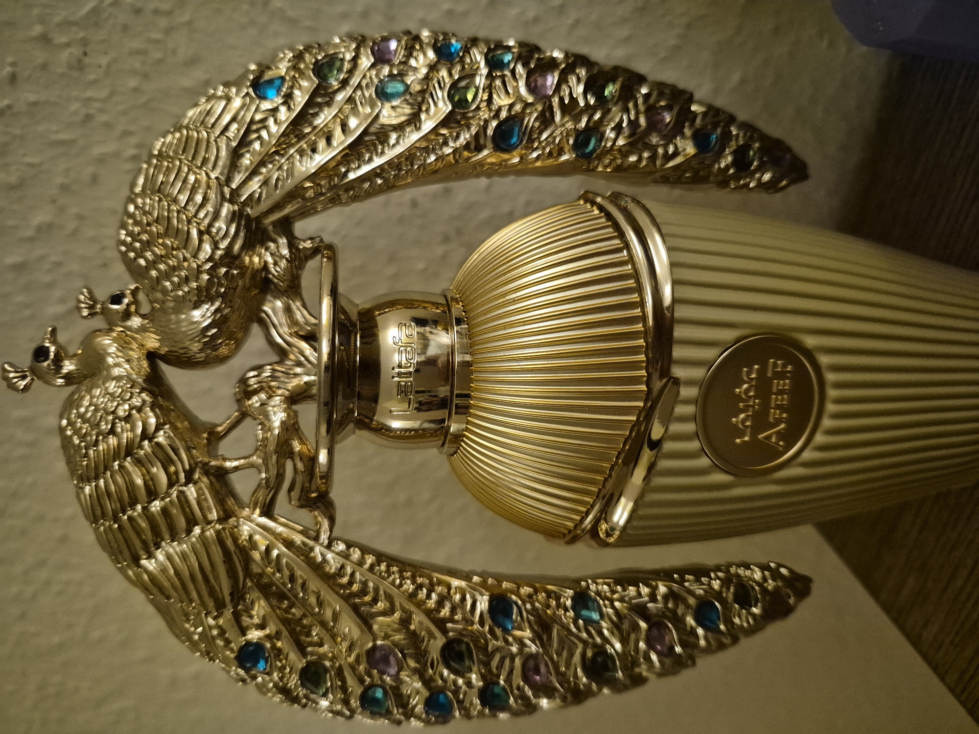 Gold peacock perfume bottle and decorative collectibles, multiple angles