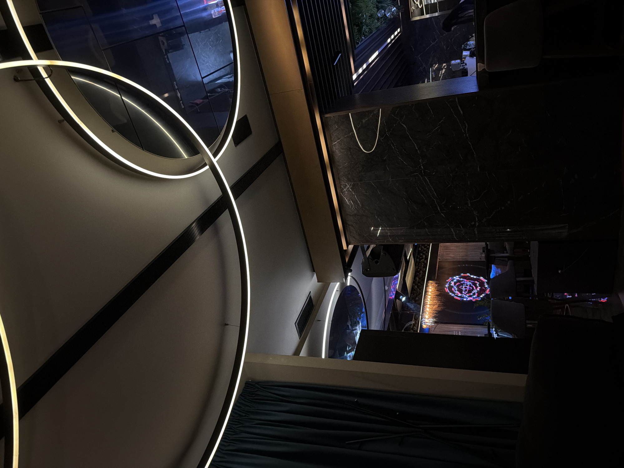 Modern interior with circular light fixtures documented by witness