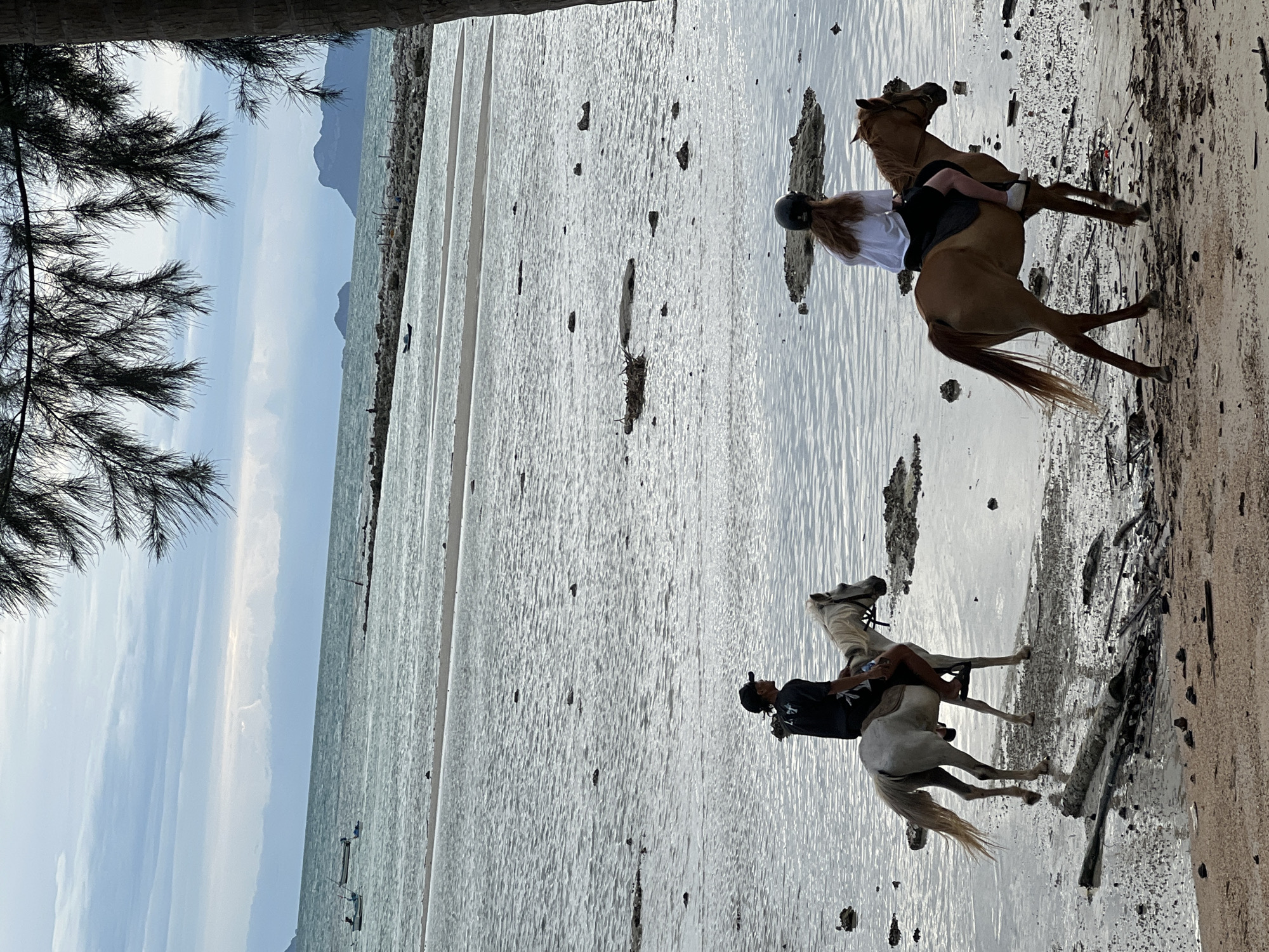 Horseback riding along the Ko Samui shoreline on a cloudy day