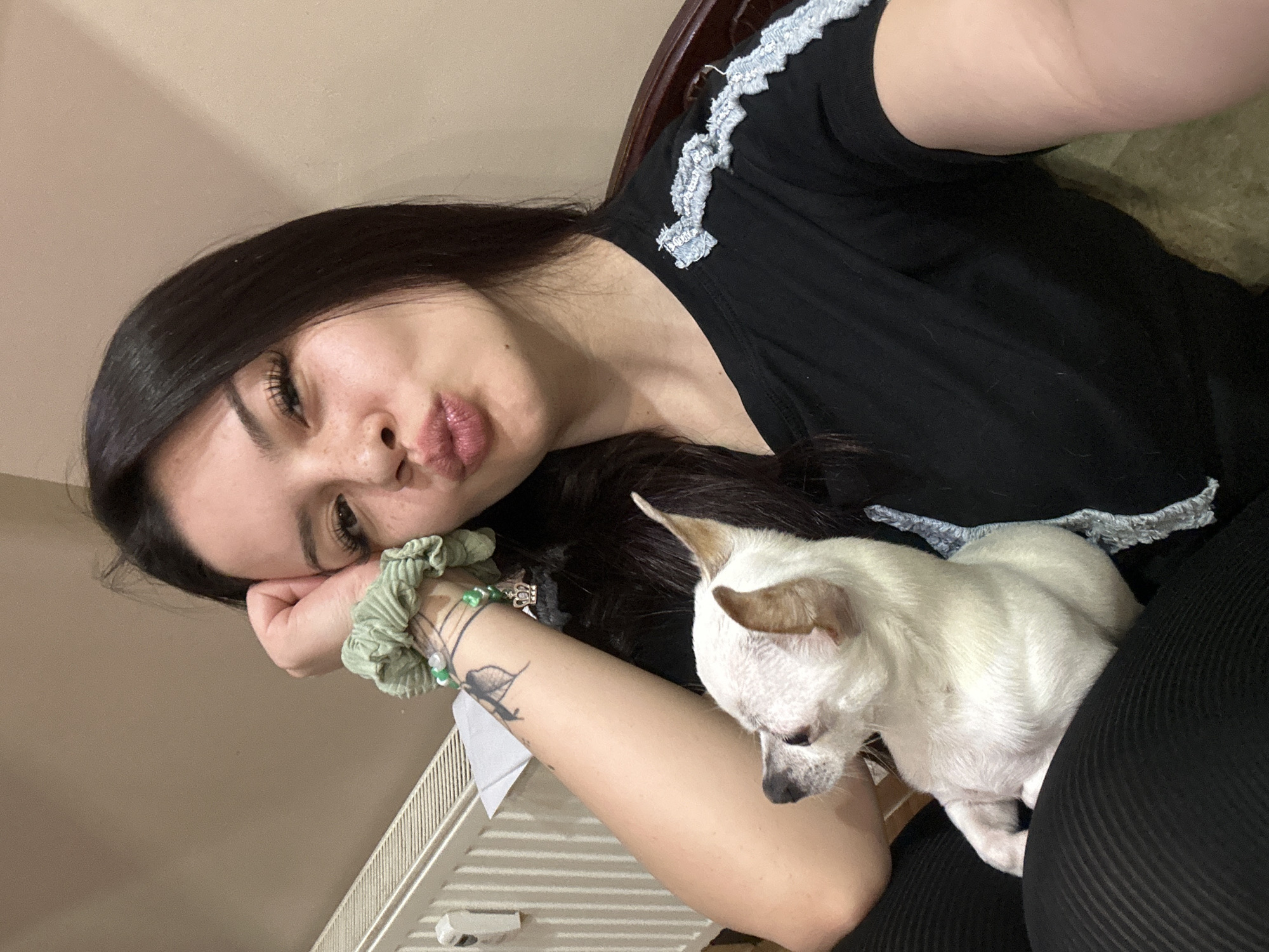 Woman poses with white dog in casual photo session