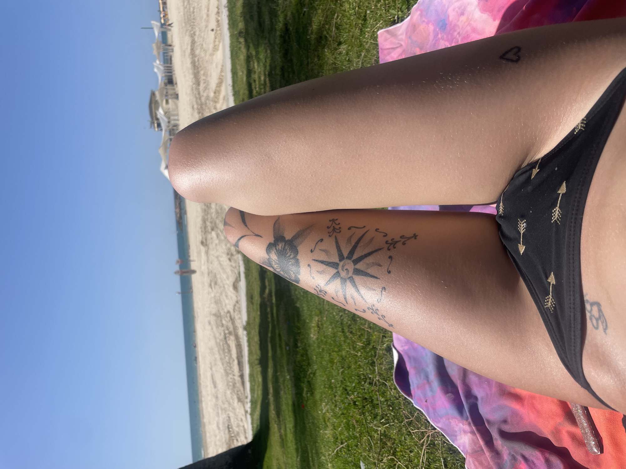 Woman sunbathes on blanket near Herzliya beach