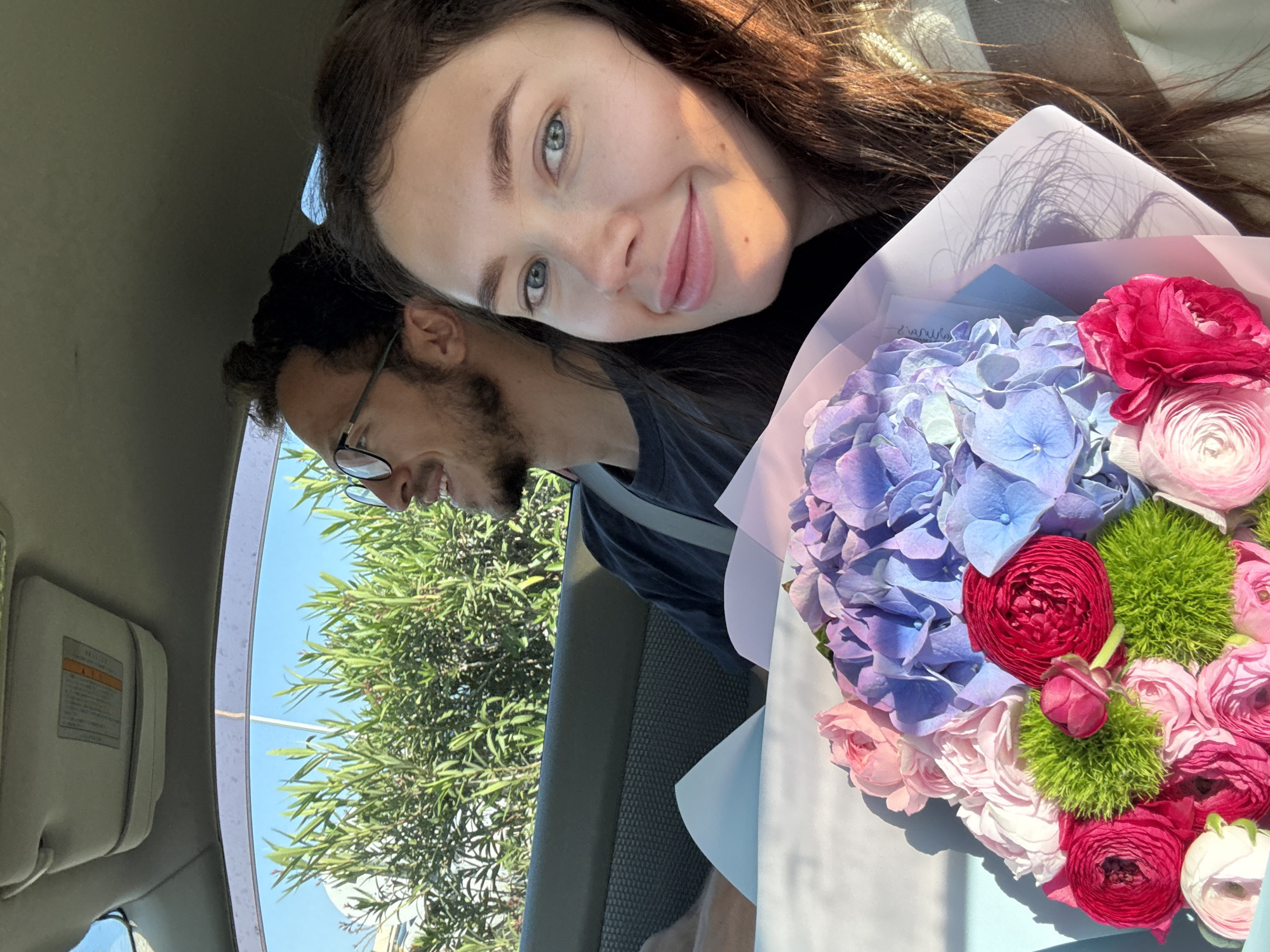 Couple shares sunny moment with flower bouquet in Cyprus