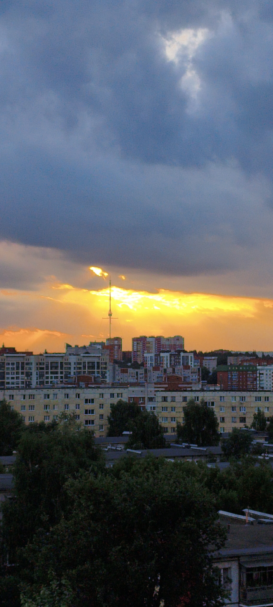 Dramatic sunset breaks through storm clouds over Izhevsk skyline