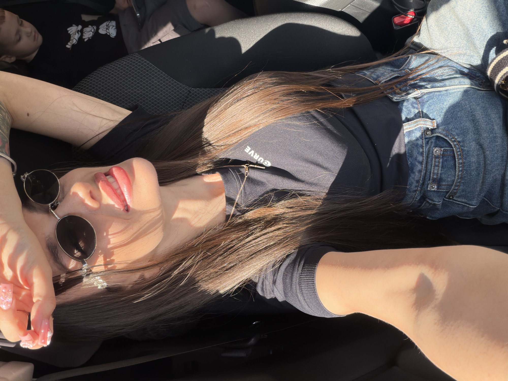 Woman and child photographed during sunny car ride in Izhevsk