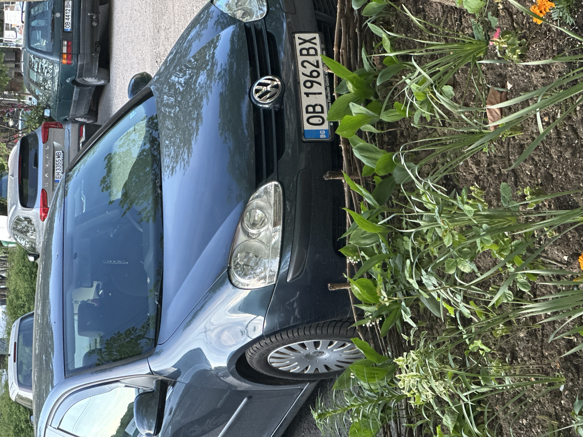 Blue Volkswagen parked near garden in Lovech, Bulgaria