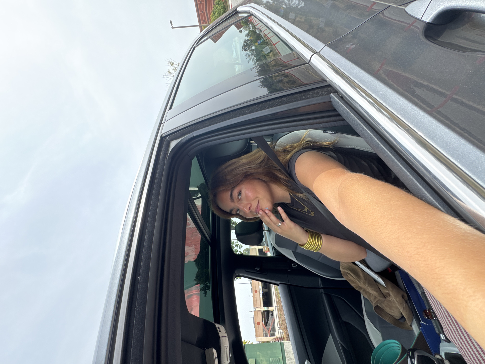 Woman photographed smiling in car in Los Angeles
