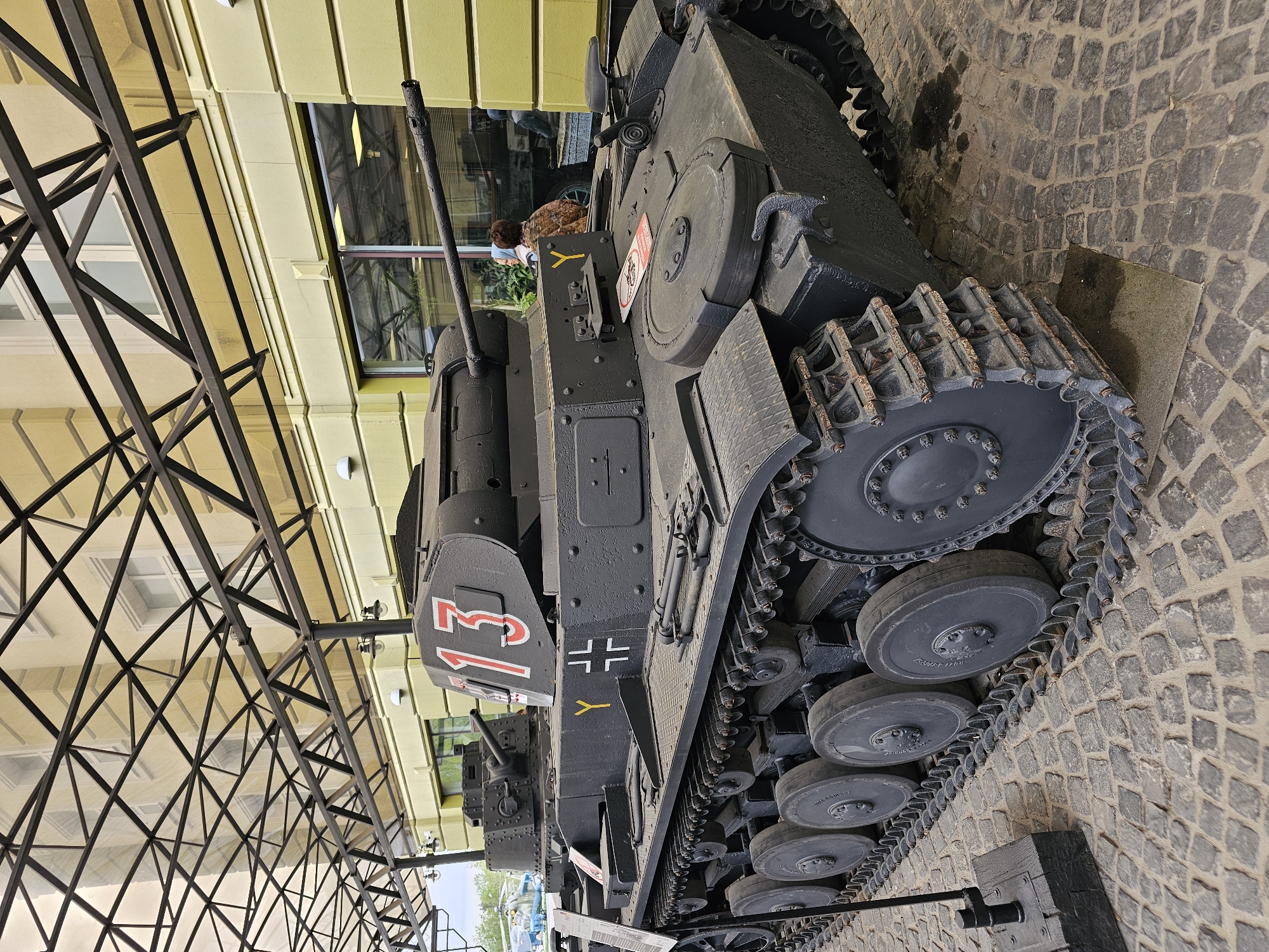 Child explores vintage military vehicle display in Arkhangel'skoye museum