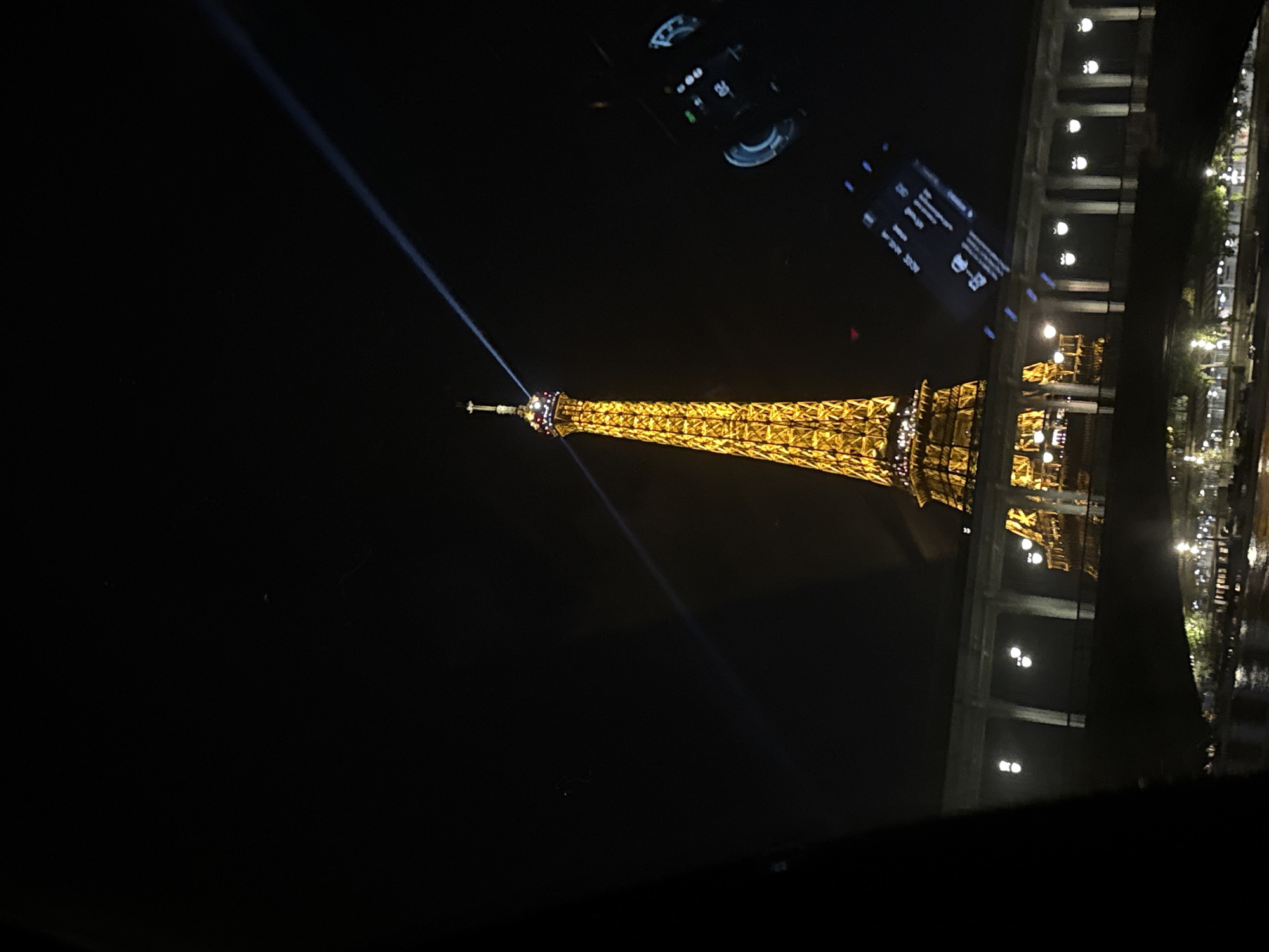 Eiffel Tower beacon illuminates Paris night sky