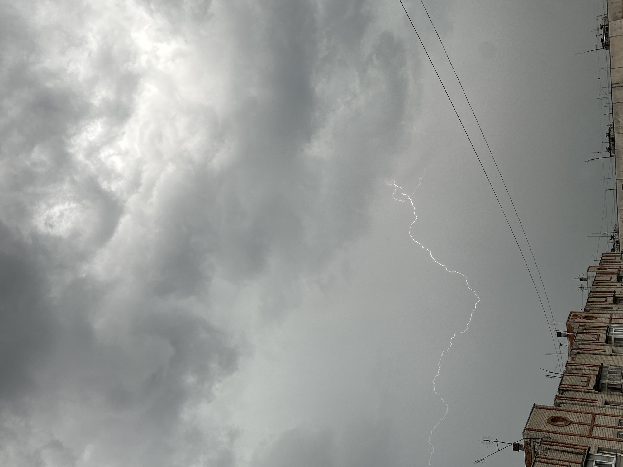 Lightning storm strikes urban area during afternoon thunderstorm