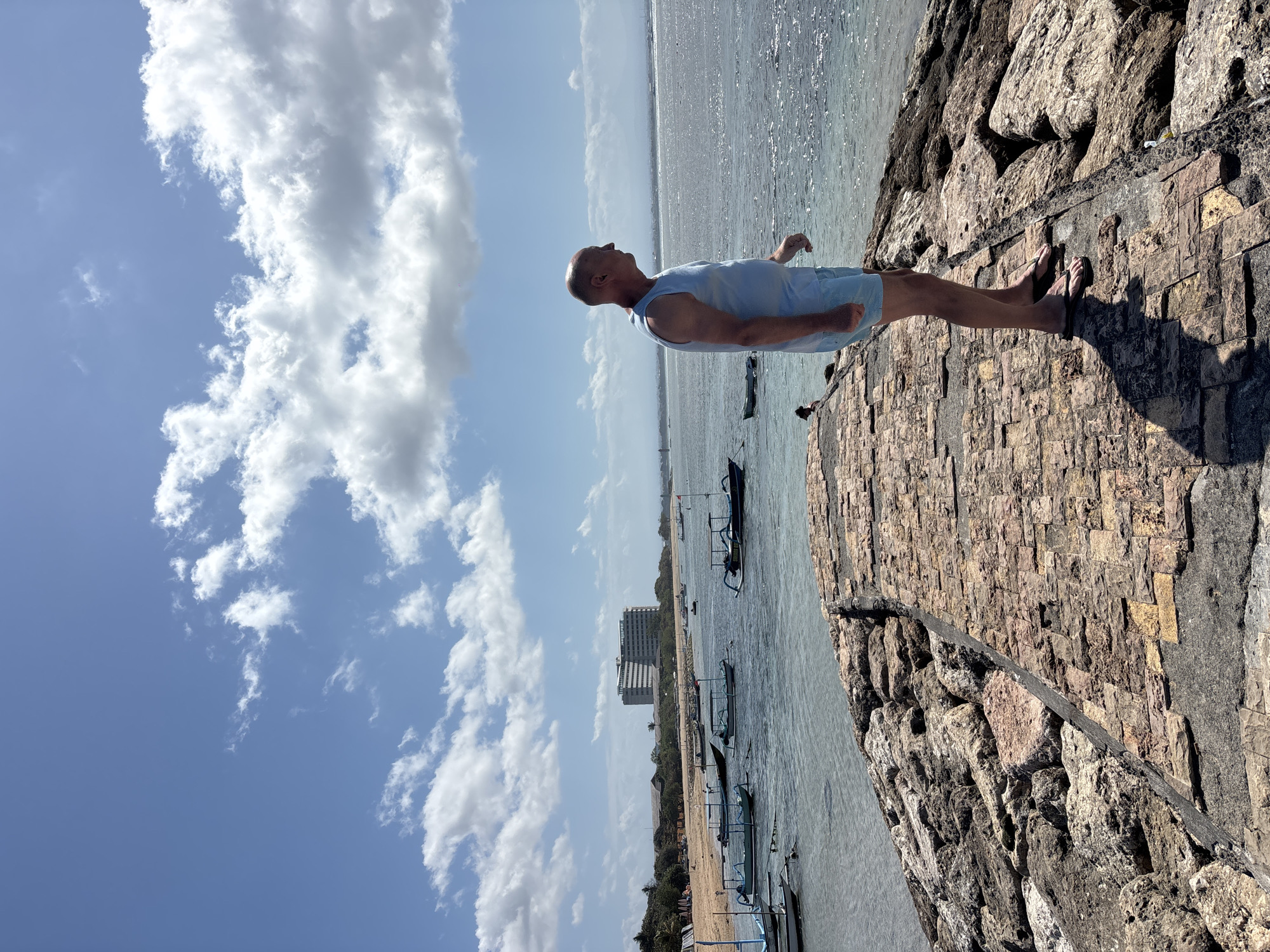 Sunny morning stroll along Denpasar's stone beachfront walkway