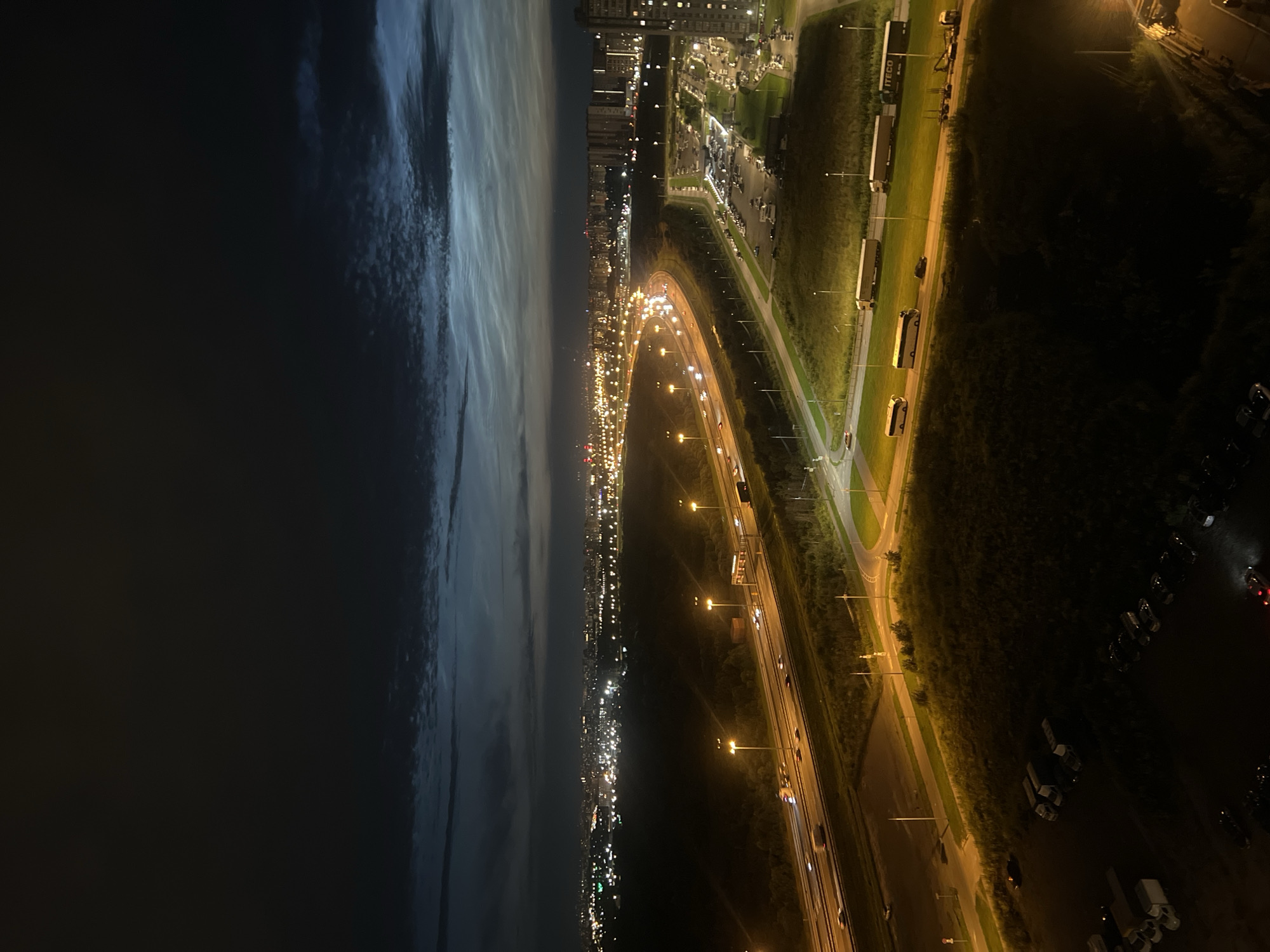Nighttime aerial views of a city grid and highway interchange.